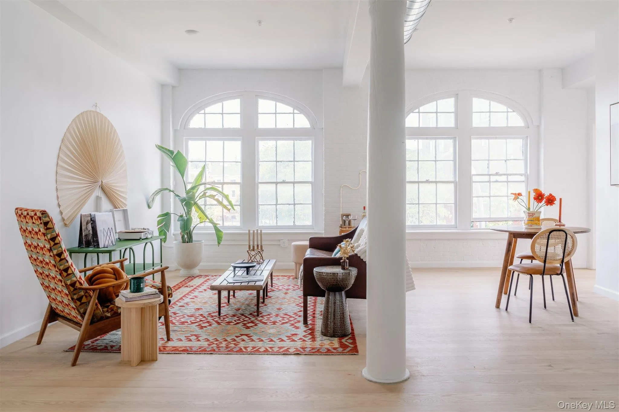 Living area with plenty of natural light and light wood-style flooring Living area with plenty of natural light and light wood-style flooring