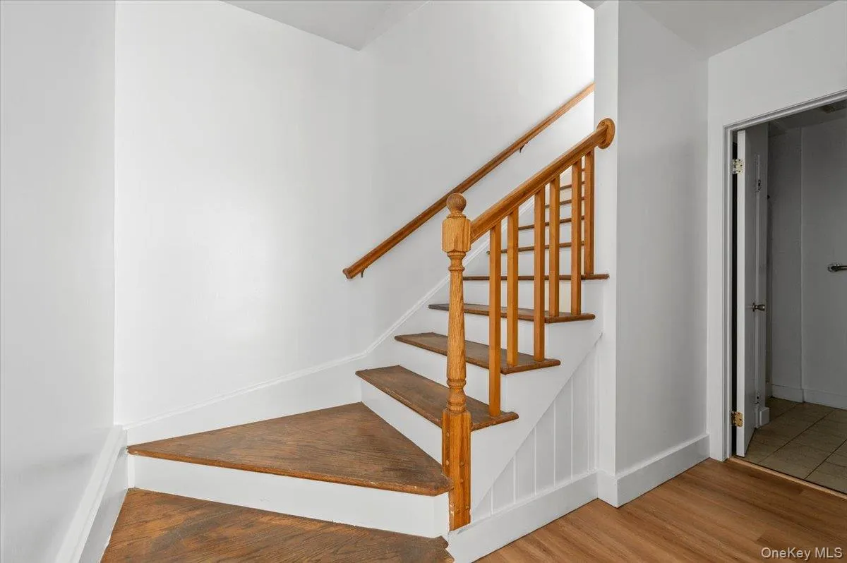 Stairway with wood finished floors and baseboards Stairway with wood finished floors and baseboards