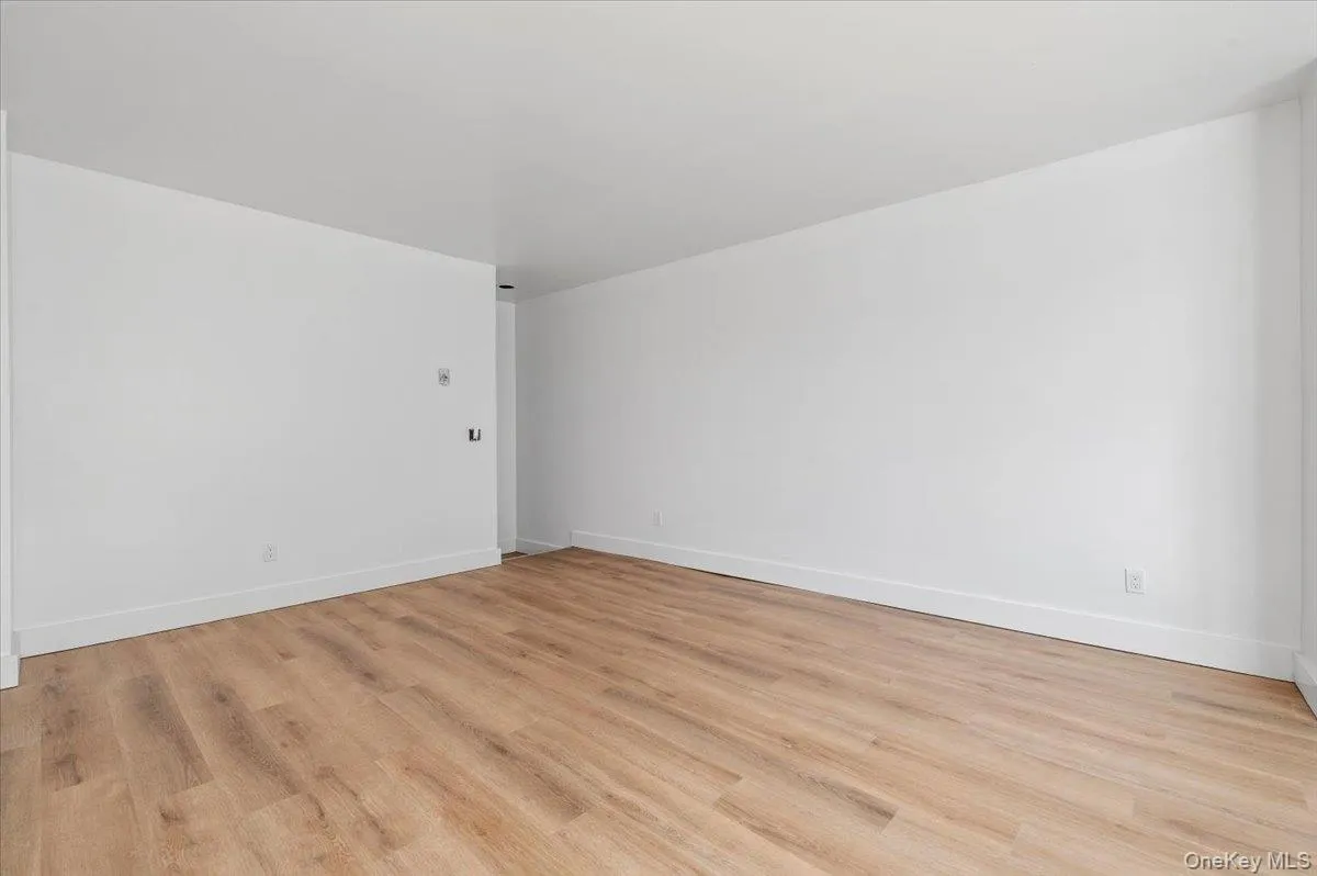 Unfurnished room featuring light wood-style flooring Unfurnished room featuring light wood-style flooring