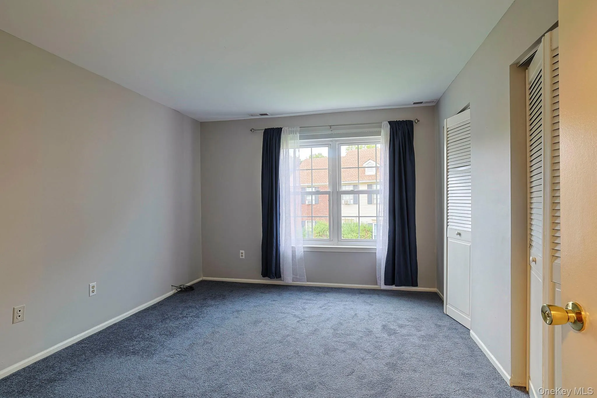 Empty room featuring carpet and baseboards Empty room featuring carpet and baseboards