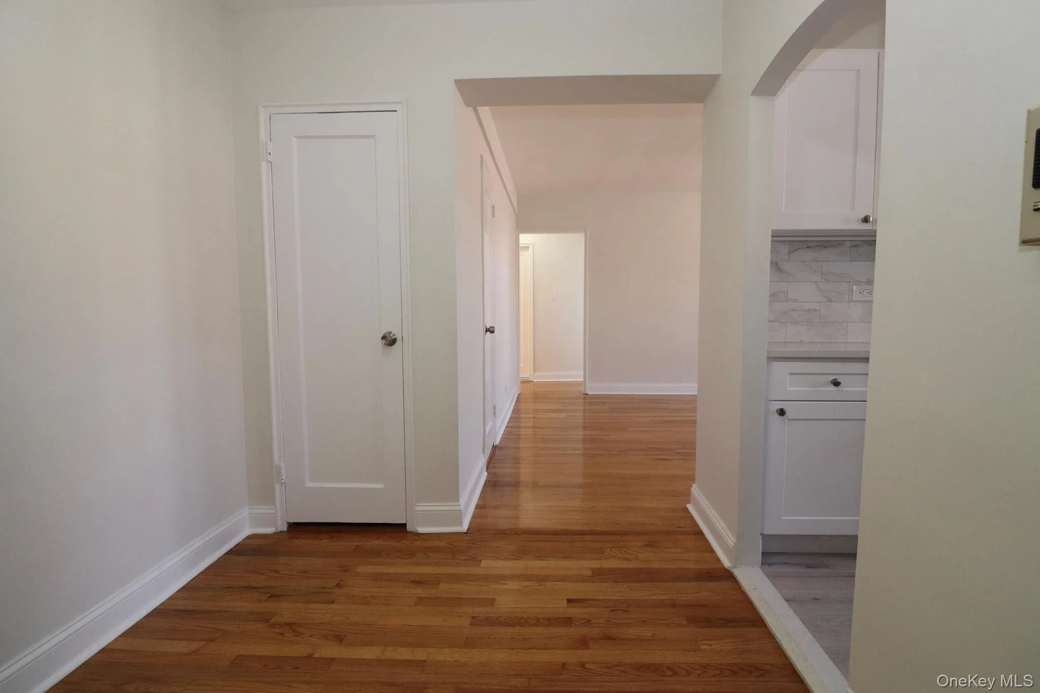 Corridor with light wood-style floors and arched walkways Corridor with light wood-style floors and arched walkways