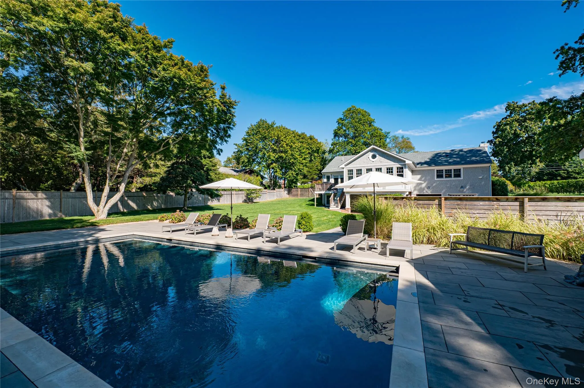 View of swimming pool with a fenced backyard and a patio