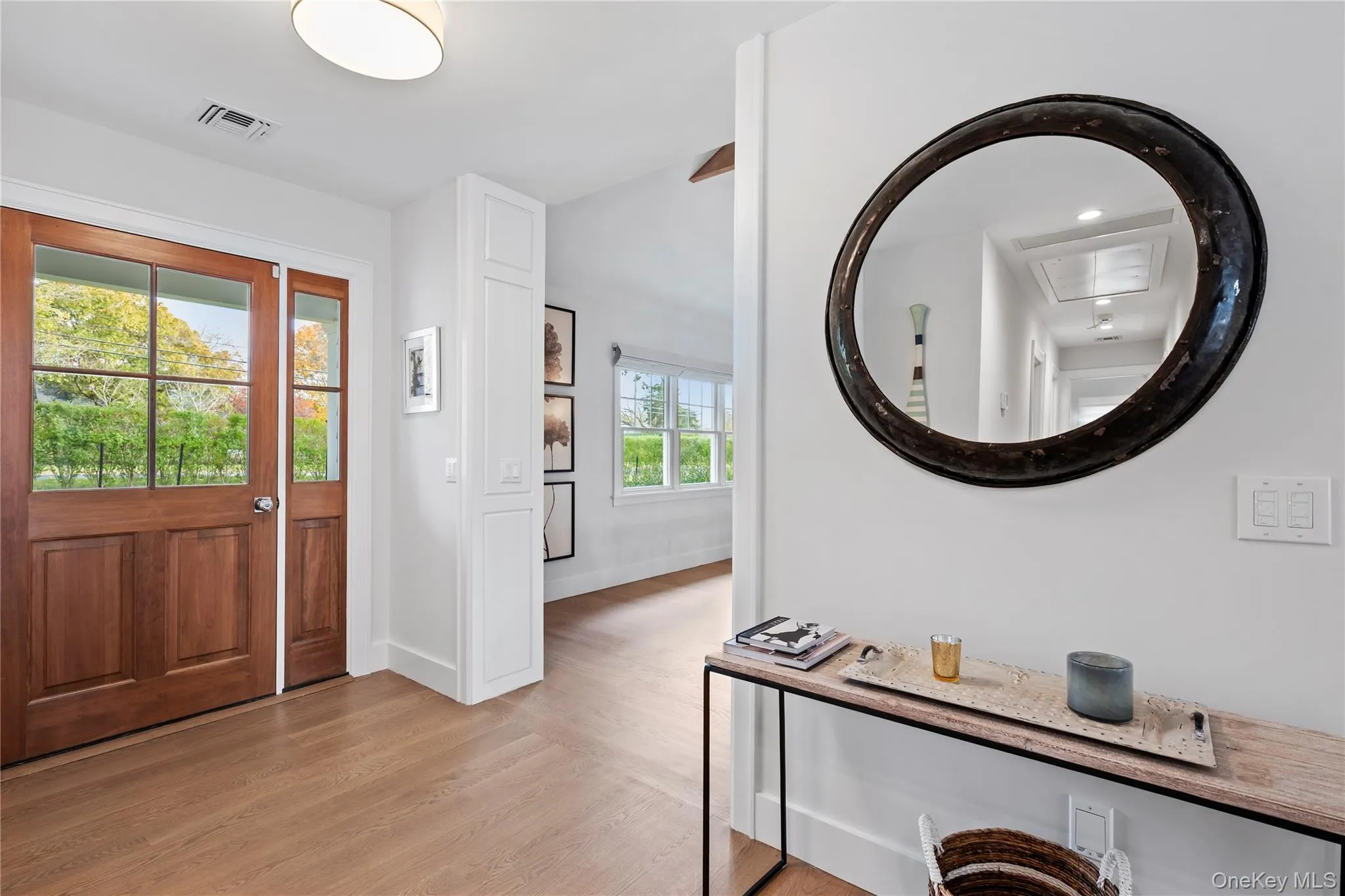 Foyer with light wood-style flooring and baseboards