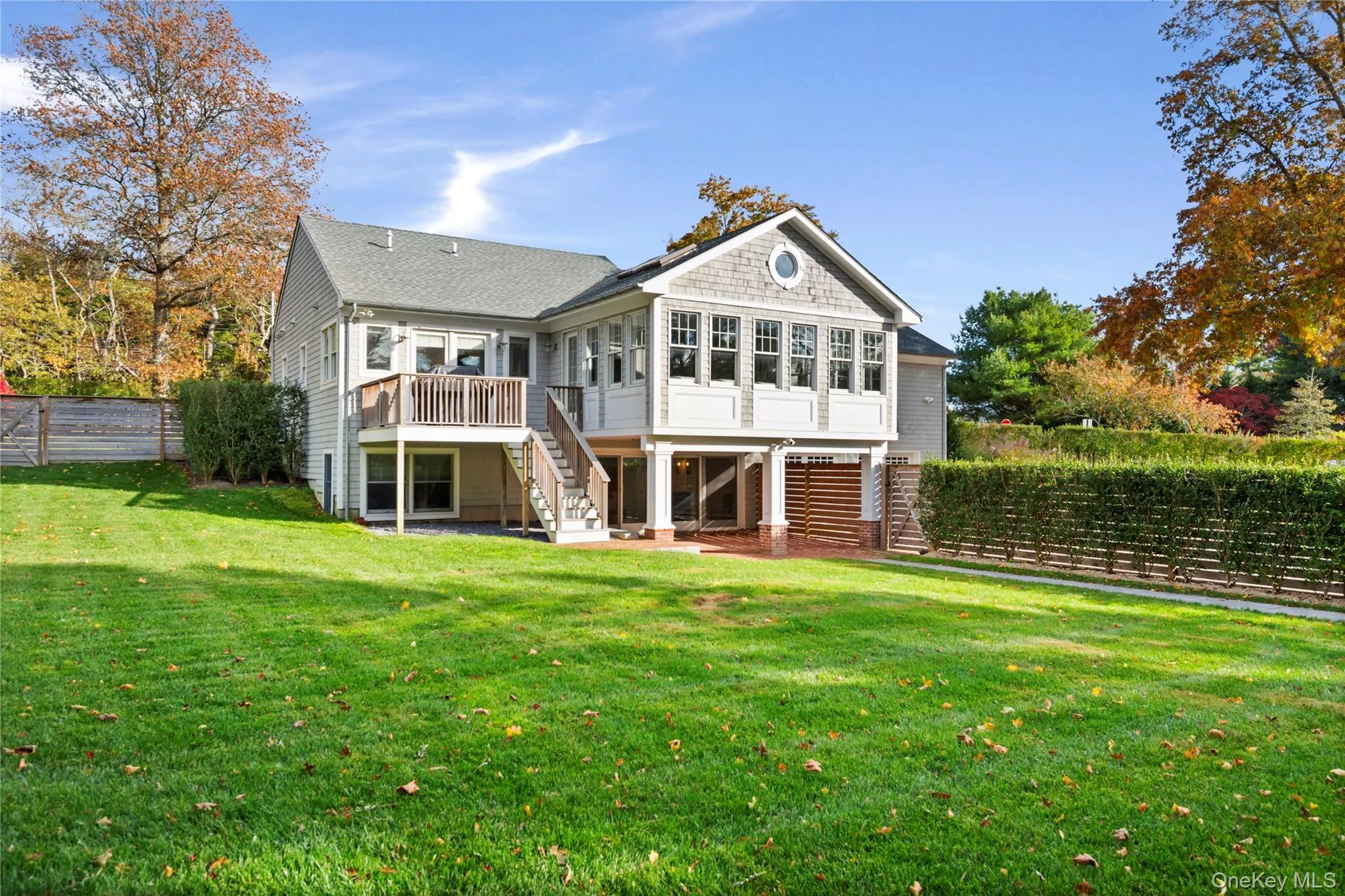 Rear view of property with a fenced backyard, stairs, a deck, and a patio area