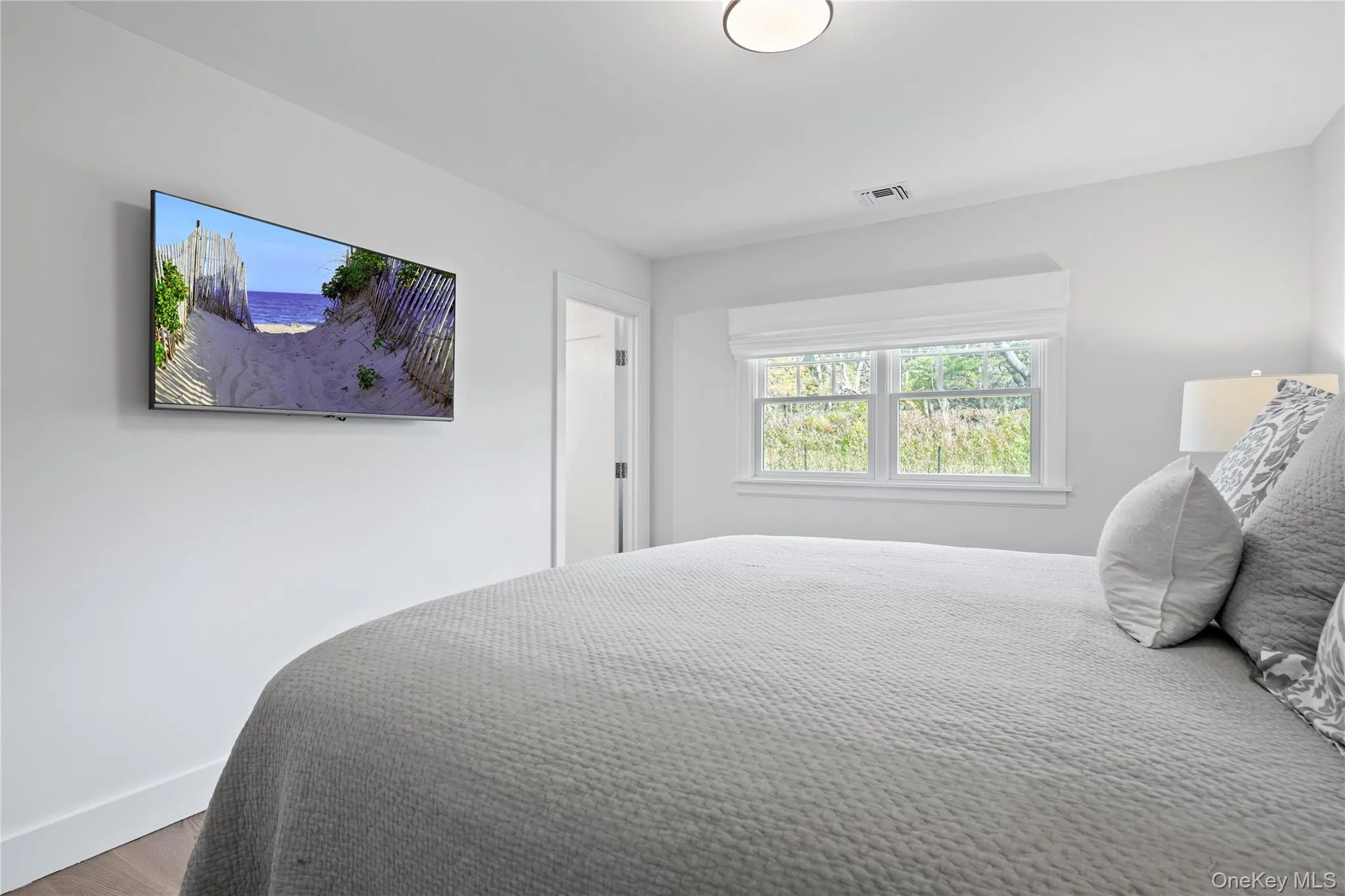 Bedroom featuring baseboards and wood finished floors