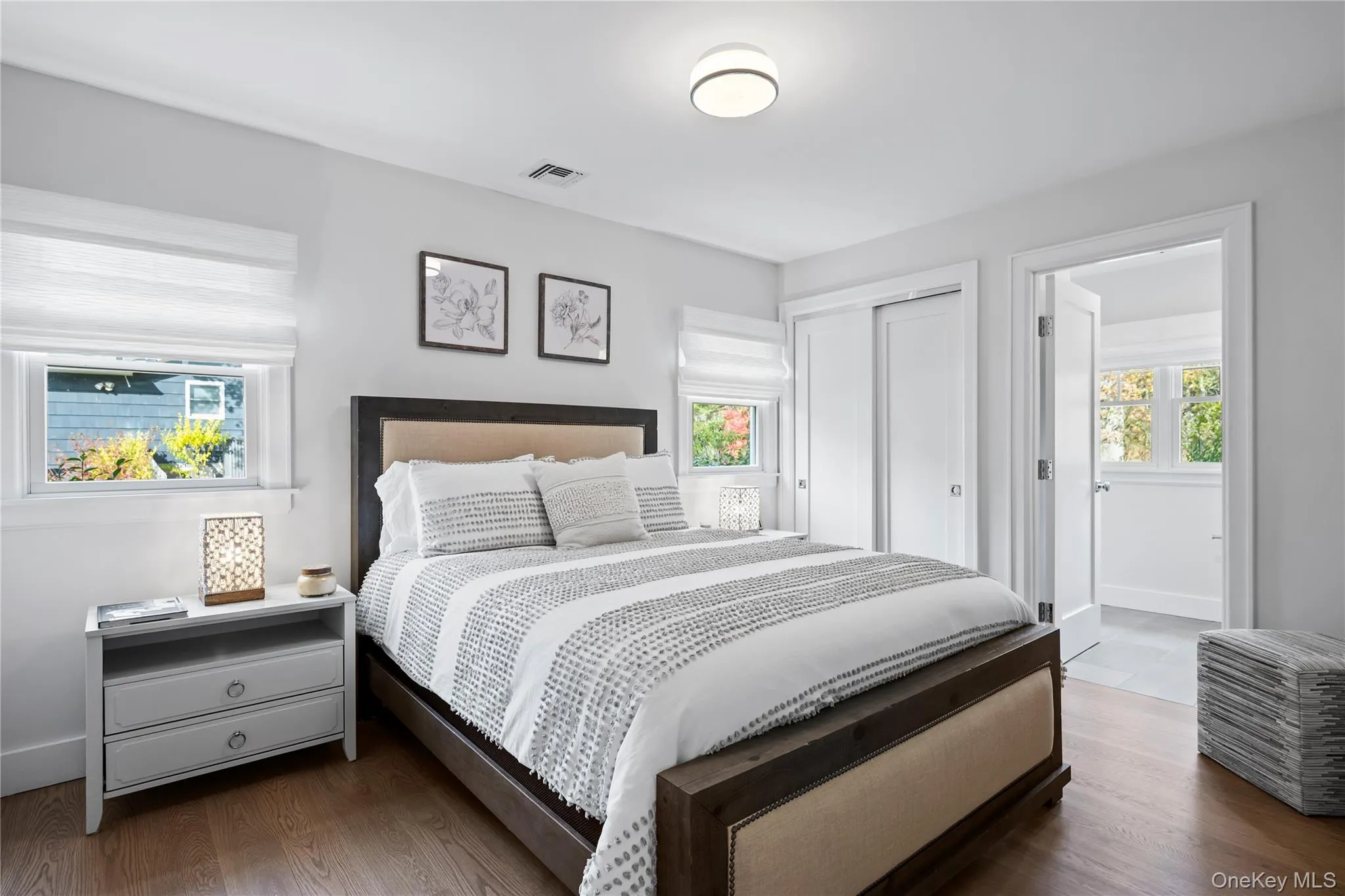 Bedroom featuring dark wood-style flooring and a closet