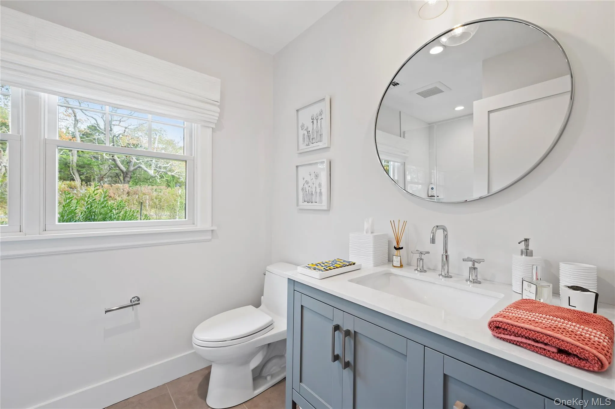 Bathroom featuring light tile patterned floors and vanity