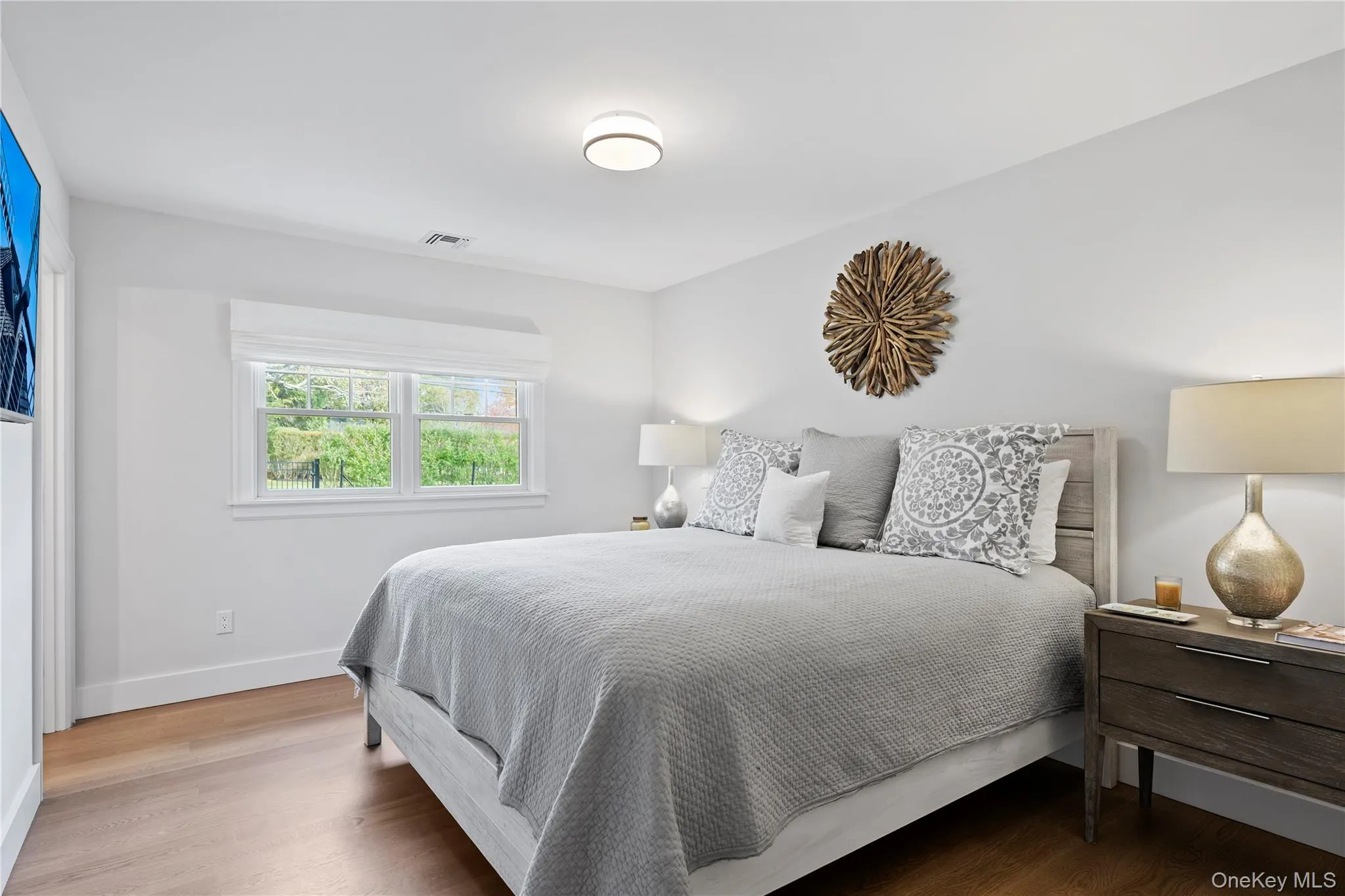 Bedroom featuring wood finished floors and baseboards