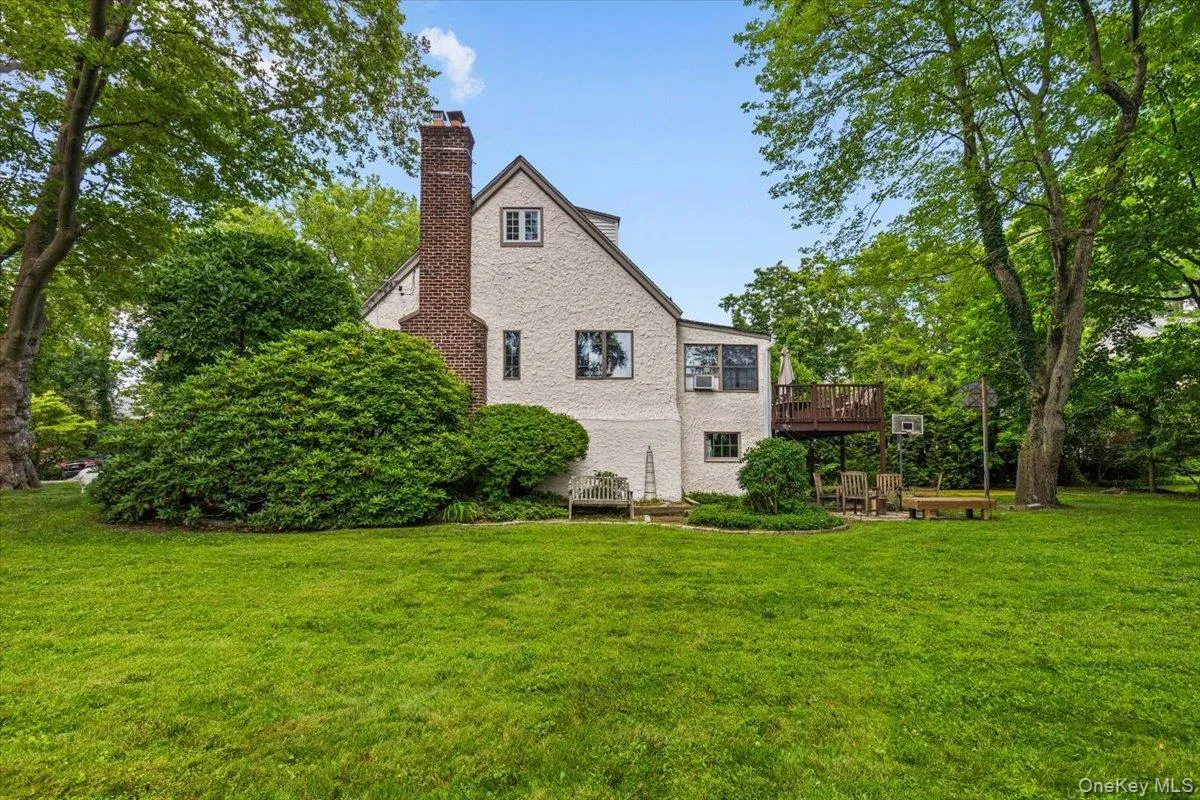 Side view of property showing the back deck and patio areas. Side view of property showing the back deck and patio areas.