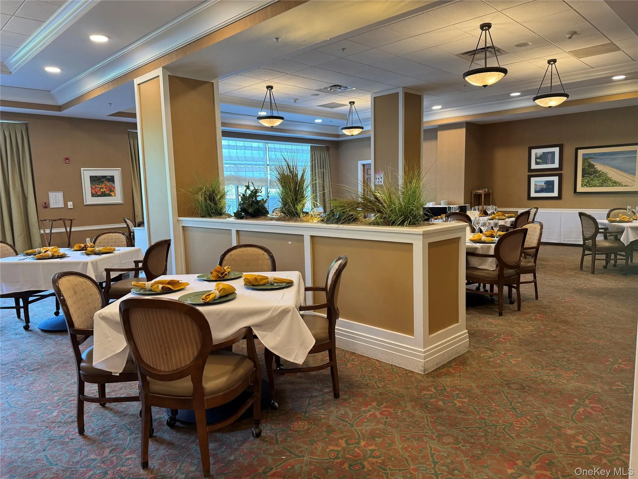 Dining room with a raised ceiling, crown molding, and recessed lighting Dining room with a raised ceiling, crown molding, and recessed lighting