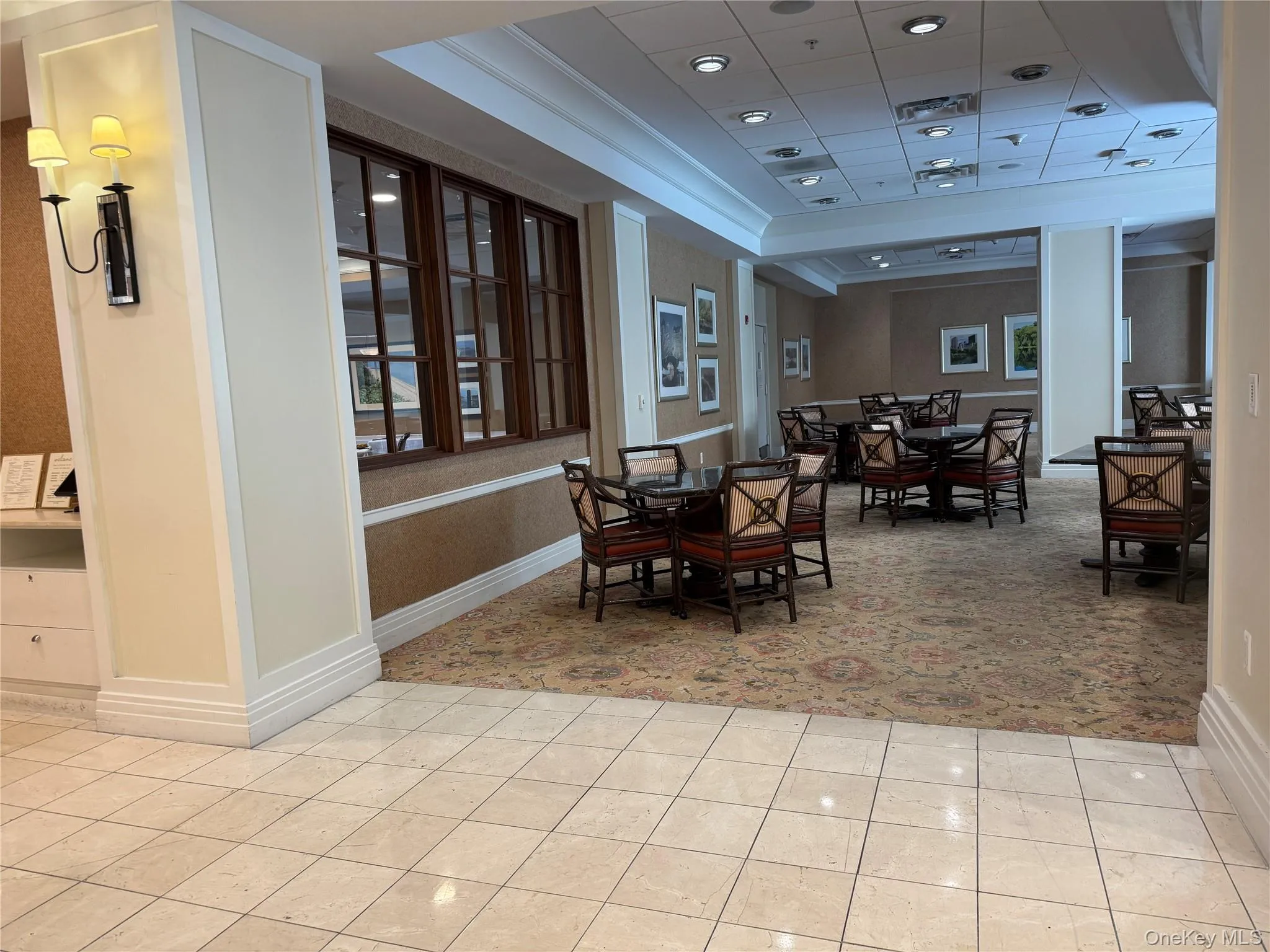 Dining space featuring a raised ceiling, light tile patterned floors, and recessed lighting Dining space featuring a raised ceiling, light tile patterned floors, and recessed lighting
