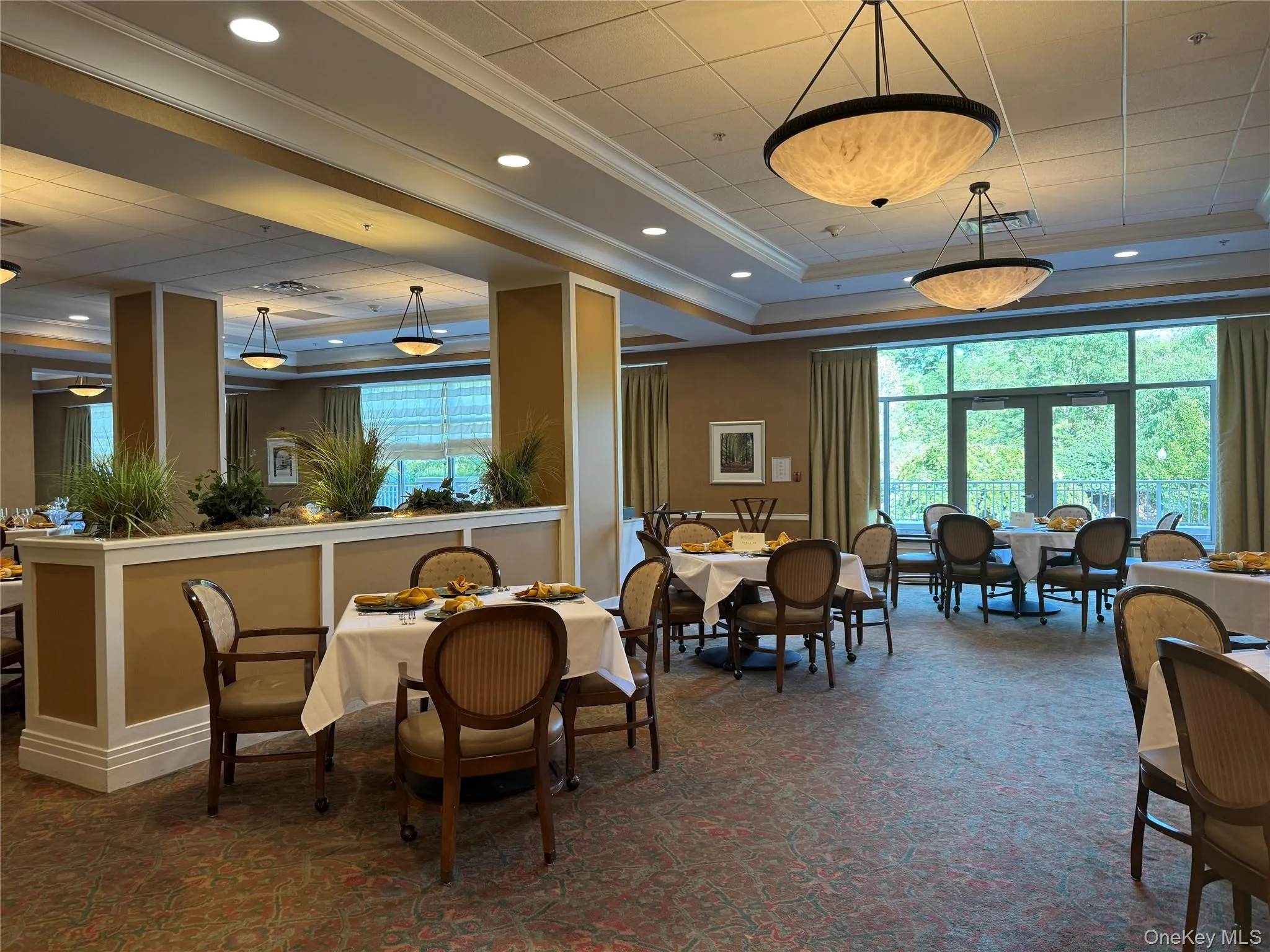 Dining area featuring a raised ceiling, ornamental molding, plenty of natural light, dark carpet, and recessed lighting Dining area featuring a raised ceiling, ornamental molding, plenty of natural light, dark carpet, and recessed lighting