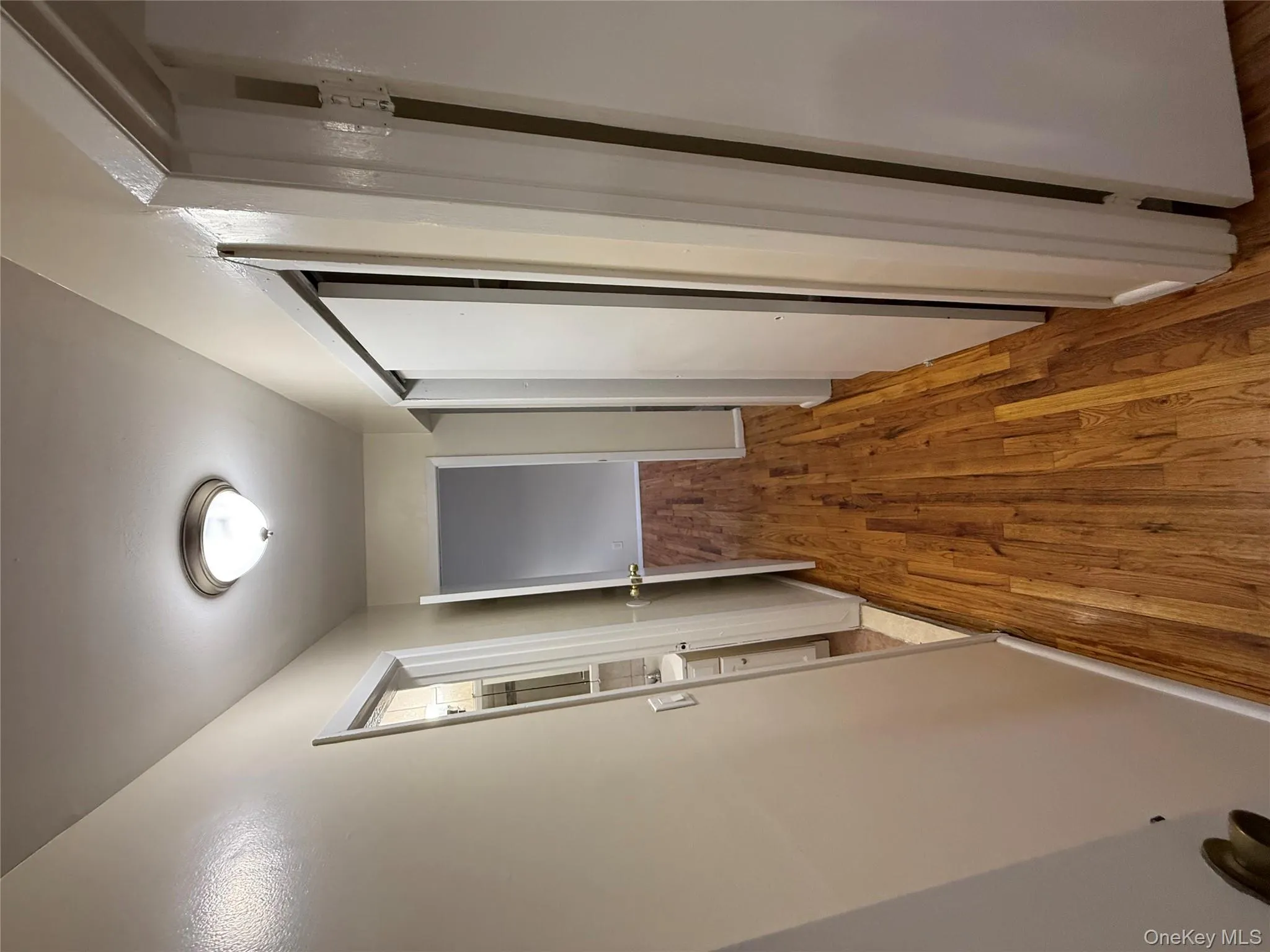 Corridor featuring wood finished floors and baseboards Corridor featuring wood finished floors and baseboards