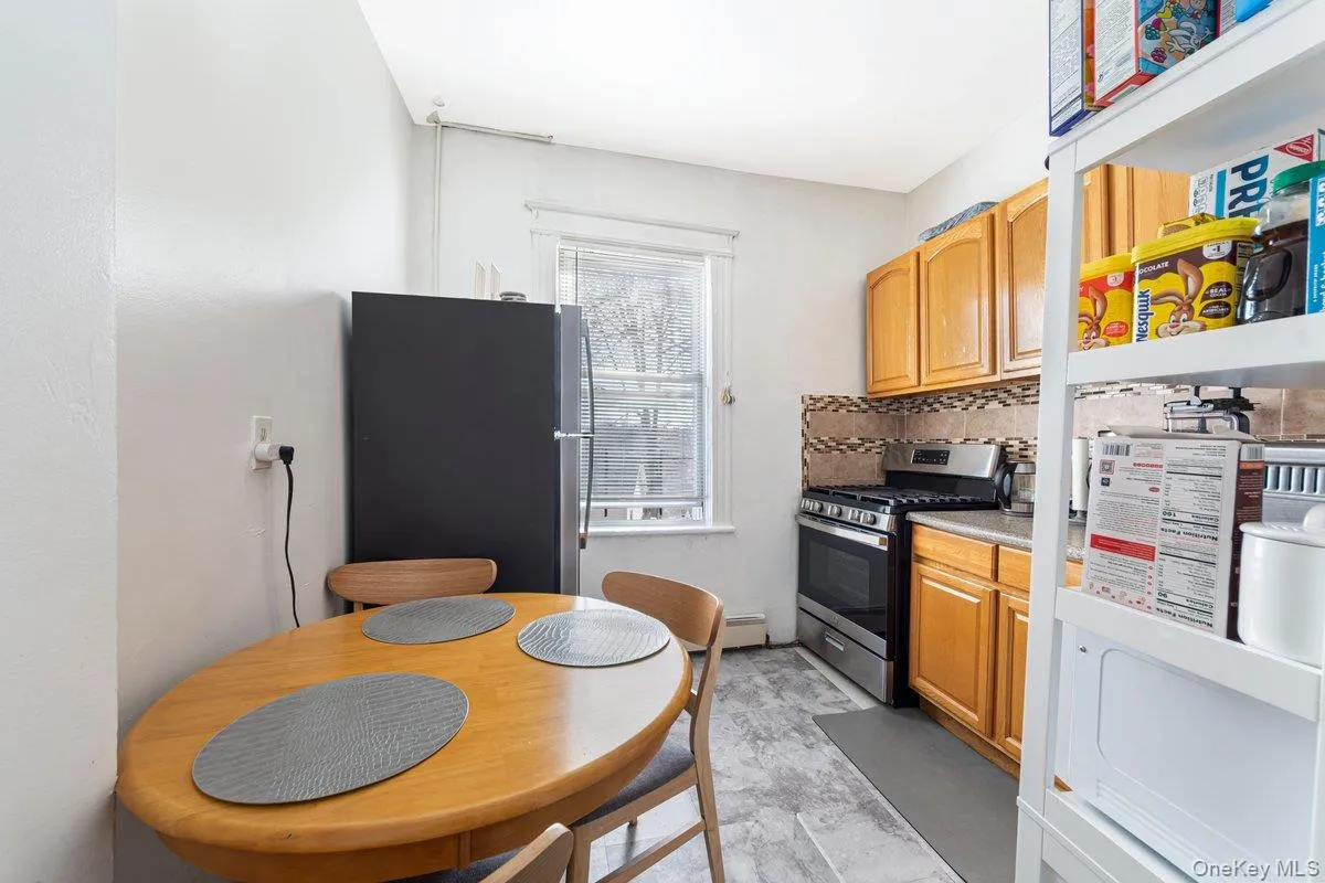 Kitchen featuring appliances with stainless steel finishes, tasteful backsplash, and light countertops Kitchen featuring appliances with stainless steel finishes, tasteful backsplash, and light countertops