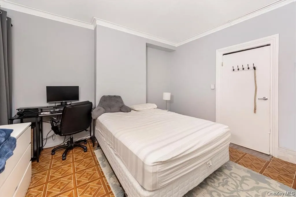 Bedroom with crown molding and an office area Bedroom with crown molding and an office area