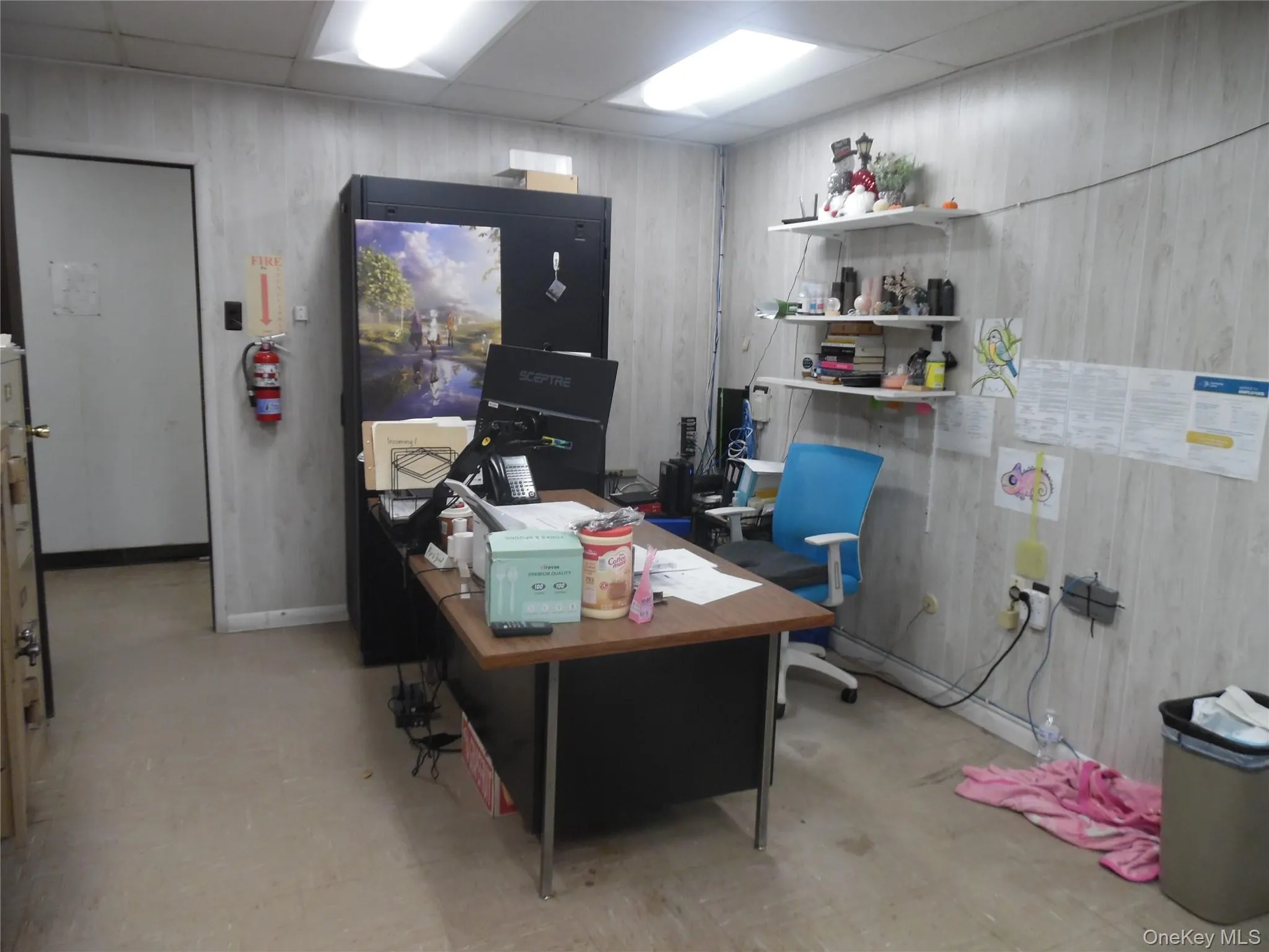 Home office with a drop ceiling and light flooring Home office with a drop ceiling and light flooring