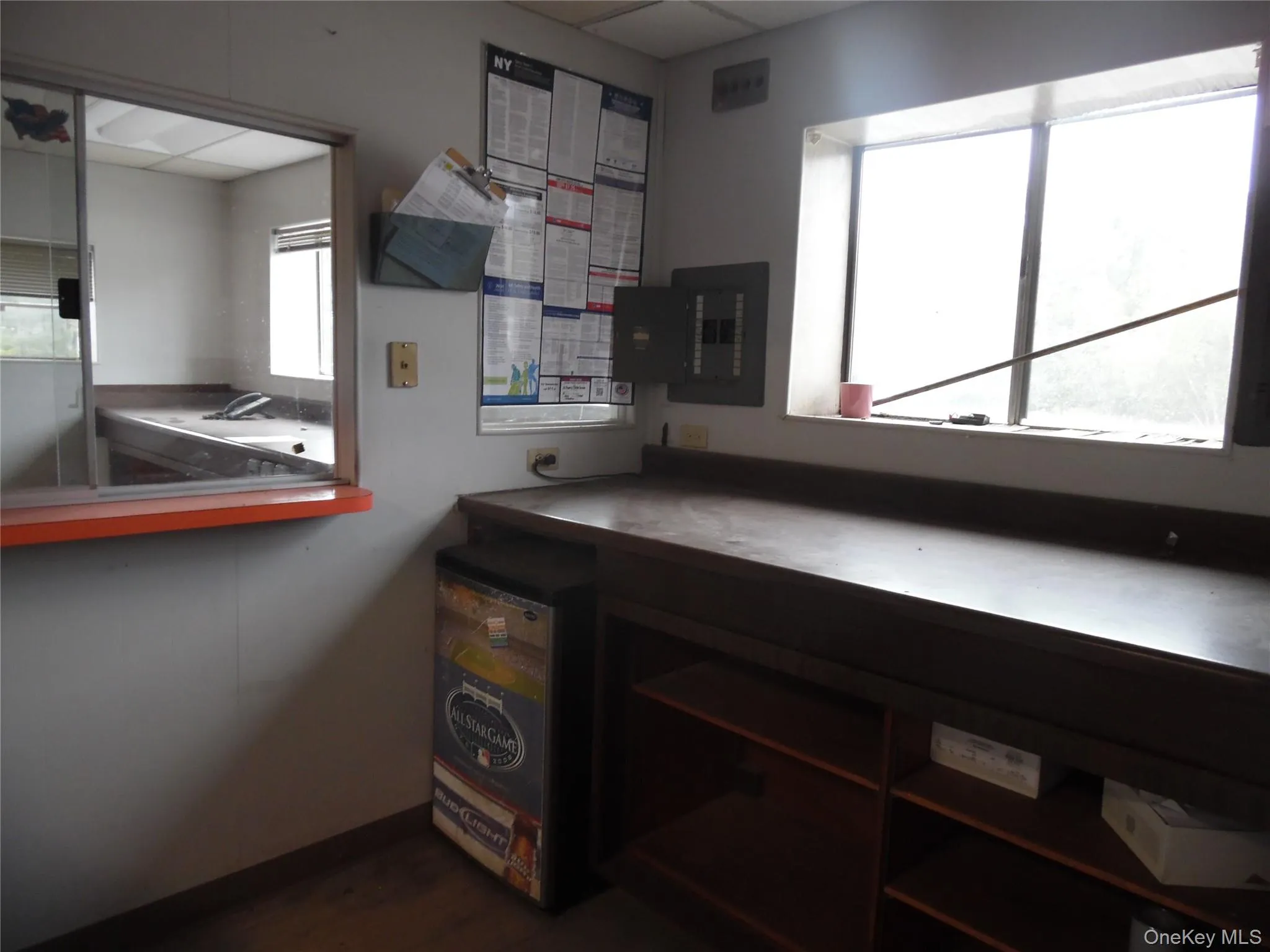 Office featuring healthy amount of natural light, electric panel, and dark wood-style floors Office featuring healthy amount of natural light, electric panel, and dark wood-style floors