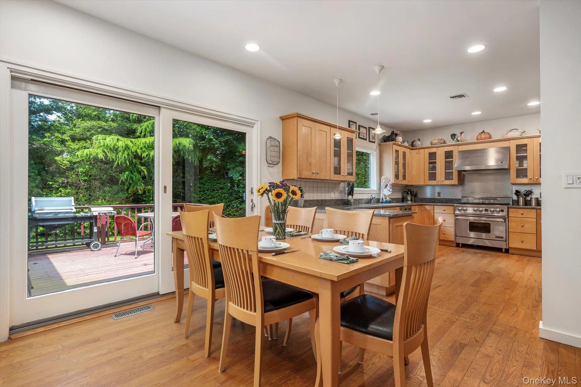 Dining room featuring light wood-type flooring and recessed lighting Dining room featuring light wood-type flooring and recessed lighting