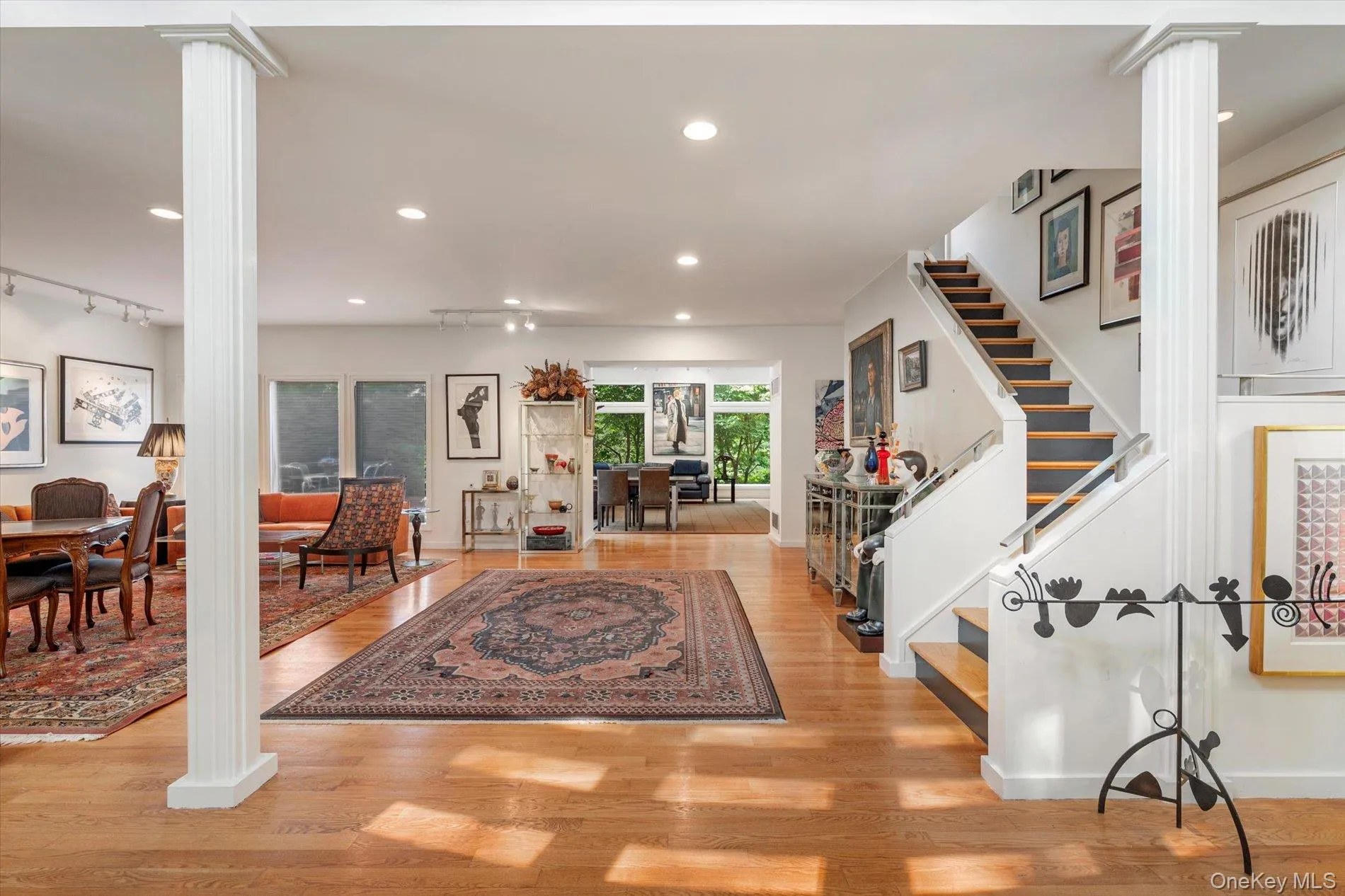 Foyer featuring decorative columns, recessed lighting, and light wood-type flooring Foyer featuring decorative columns, recessed lighting, and light wood-type flooring
