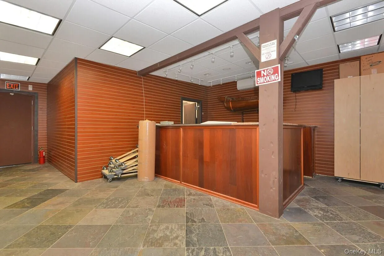 Reception area with a paneled ceiling and wooden walls Reception area with a paneled ceiling and wooden walls