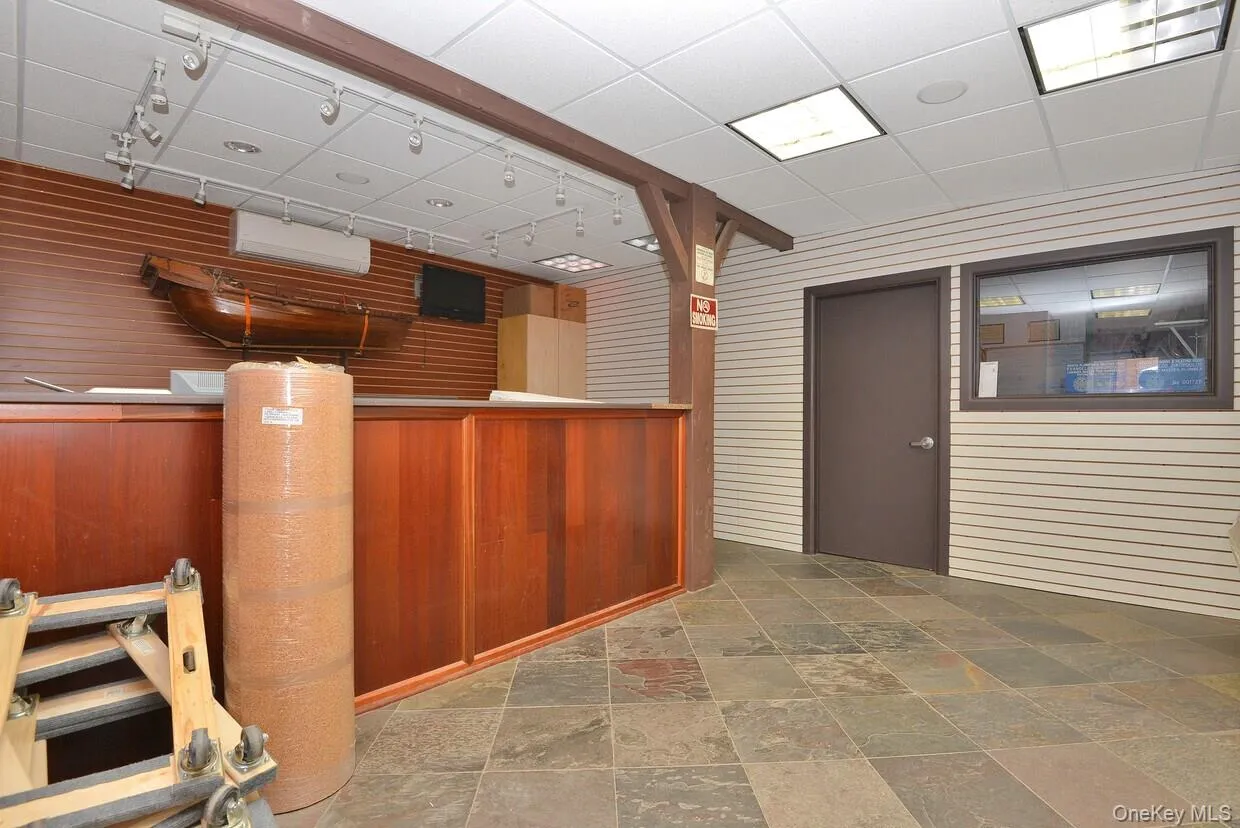 Welcome area with wooden walls and a paneled ceiling Welcome area with wooden walls and a paneled ceiling