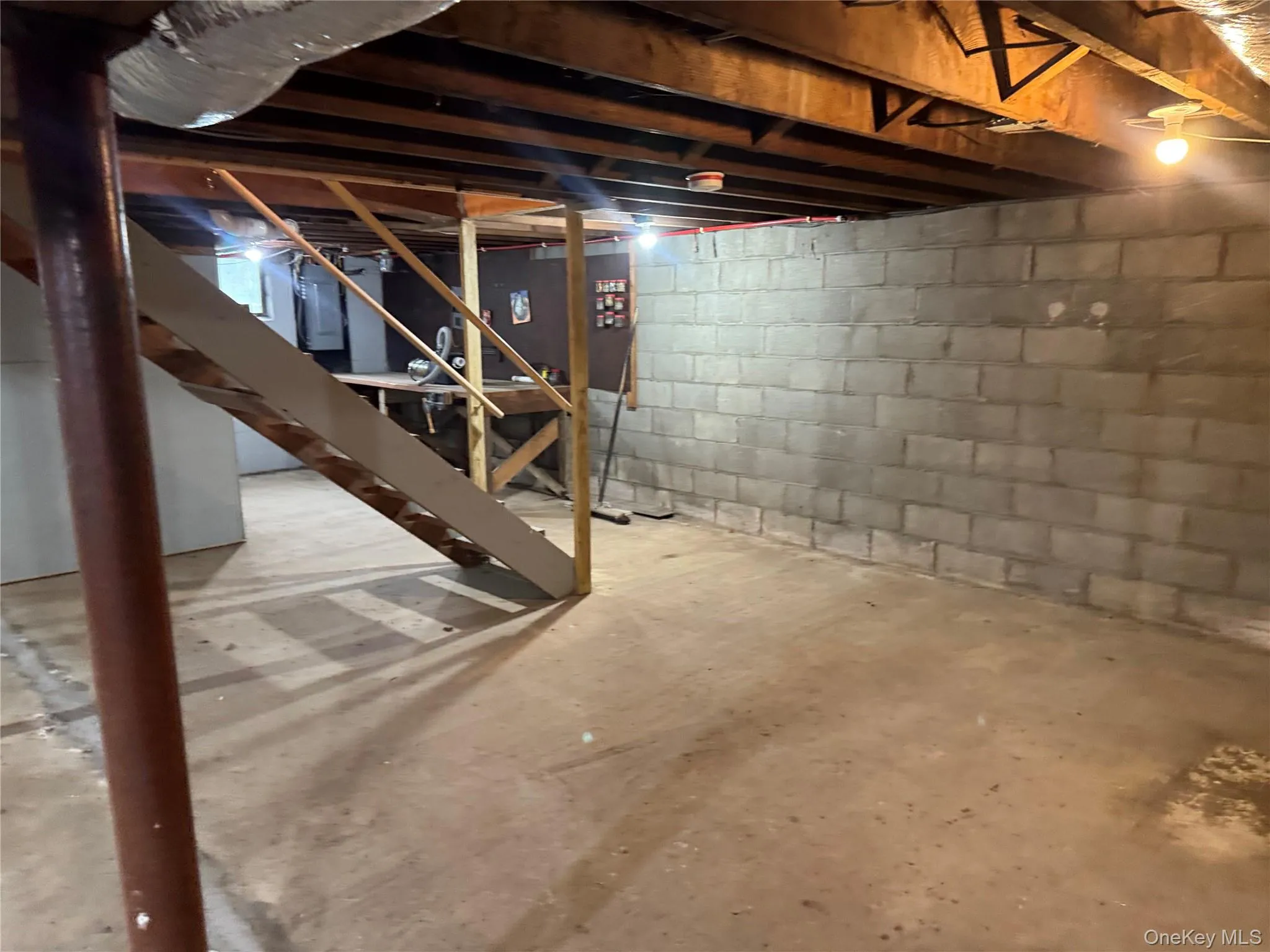 Unfinished below grade area with stairway Unfinished below grade area with stairway