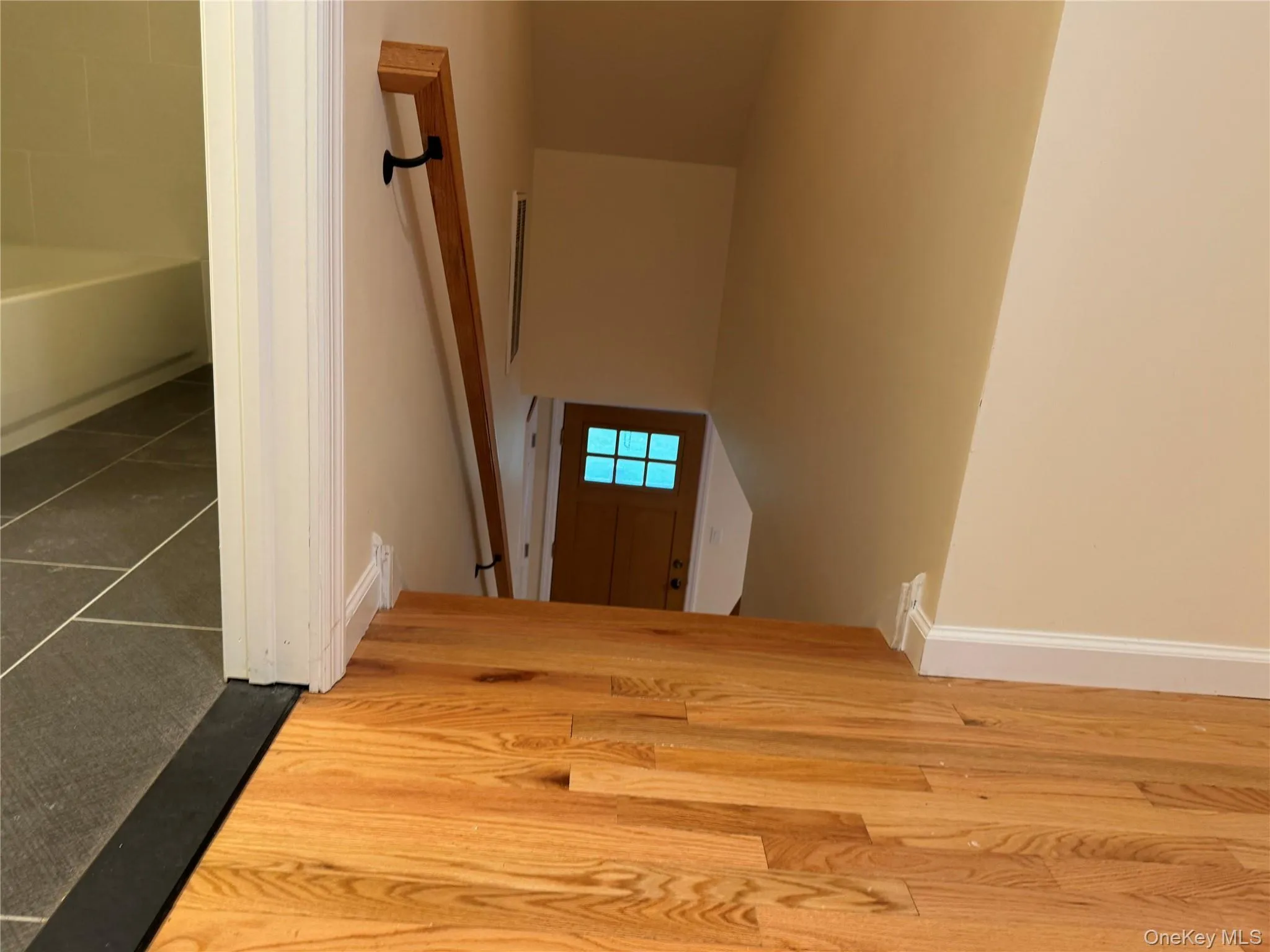 Stairs with baseboards and tile patterned flooring Stairs with baseboards and tile patterned flooring