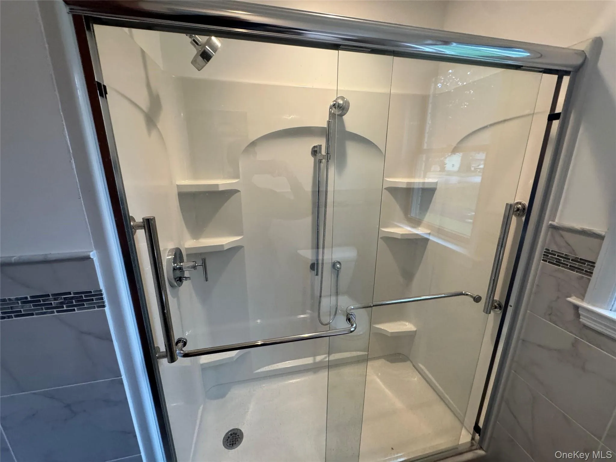 Bathroom featuring a stall shower Bathroom featuring a stall shower