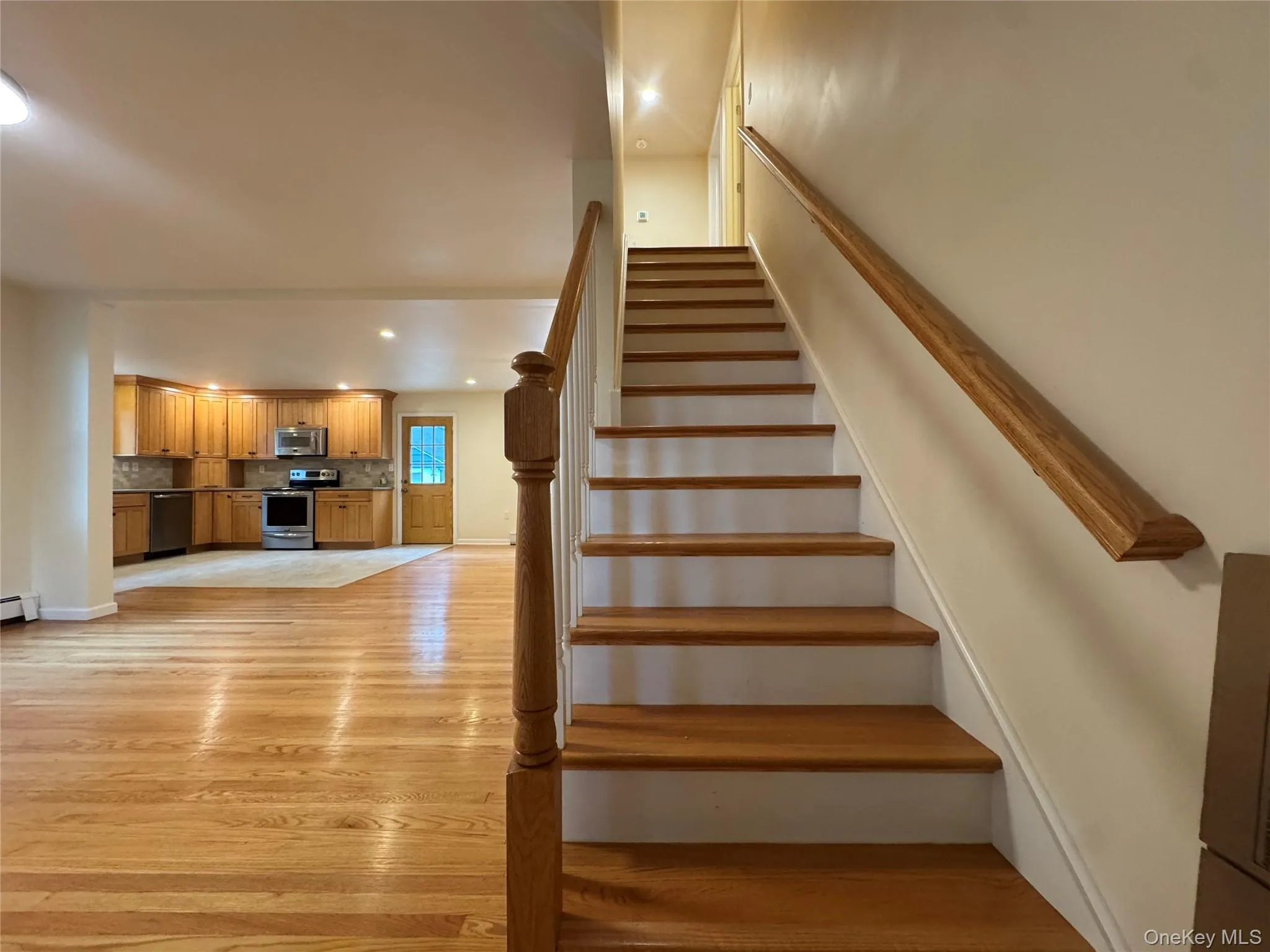 Stairs with wood finished floors and recessed lighting Stairs with wood finished floors and recessed lighting