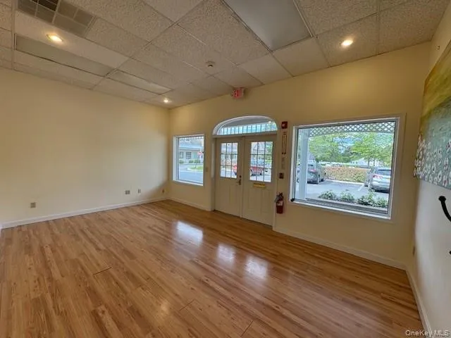 Foyer featuring light wood-style flooring, a paneled ceiling Foyer featuring light wood-style flooring, a paneled ceiling