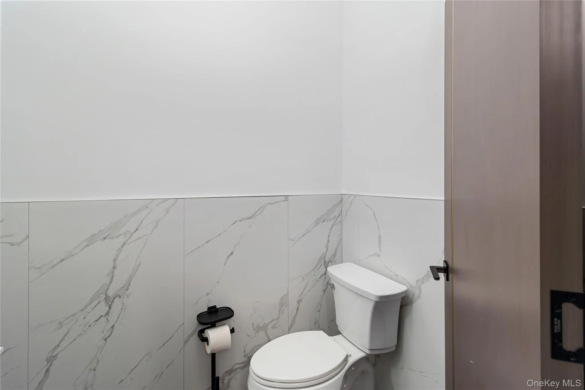 Bathroom with toilet and tile walls Bathroom with toilet and tile walls