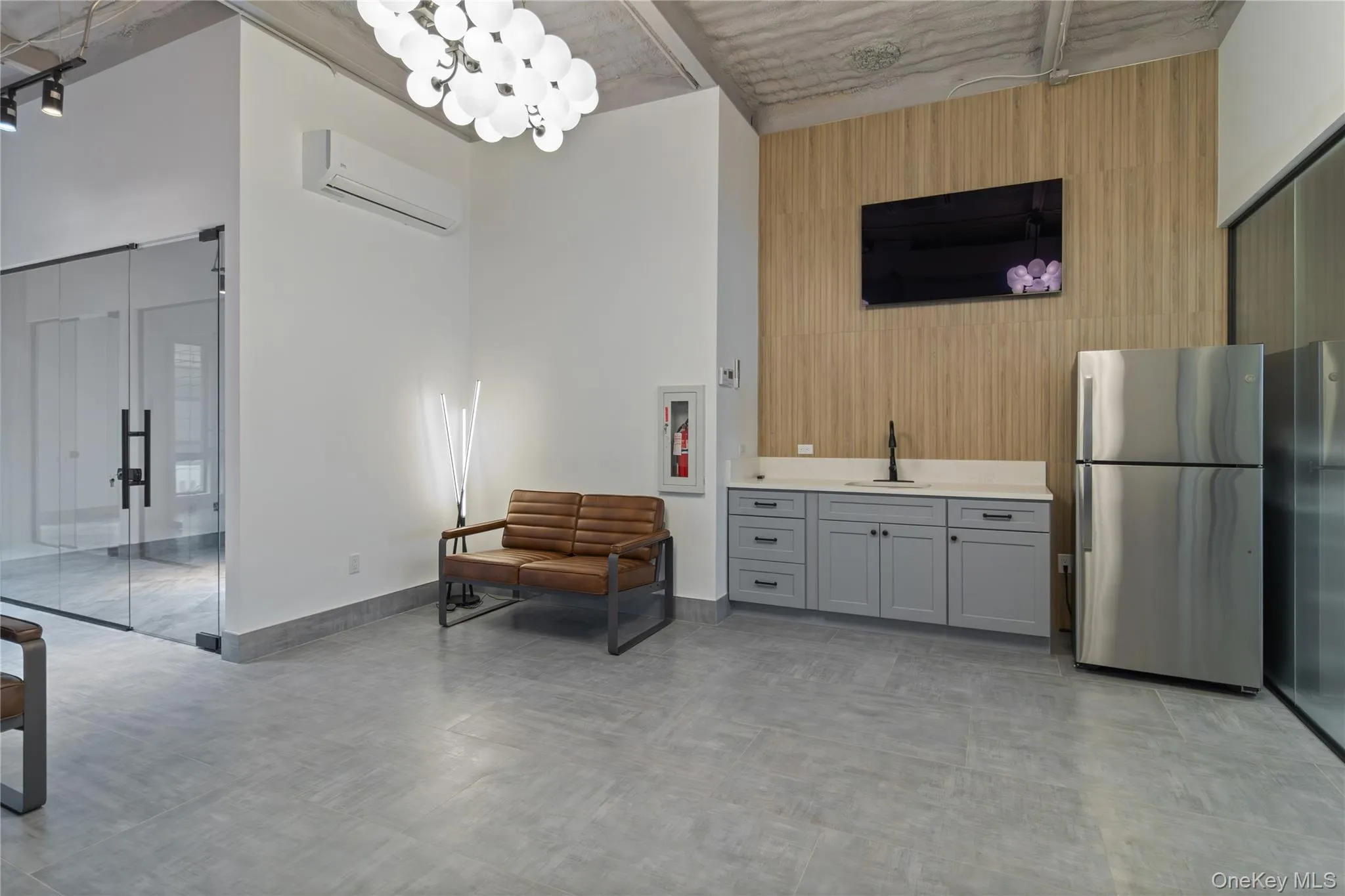 Dining room with a wall mounted AC and a high ceiling Dining room with a wall mounted AC and a high ceiling