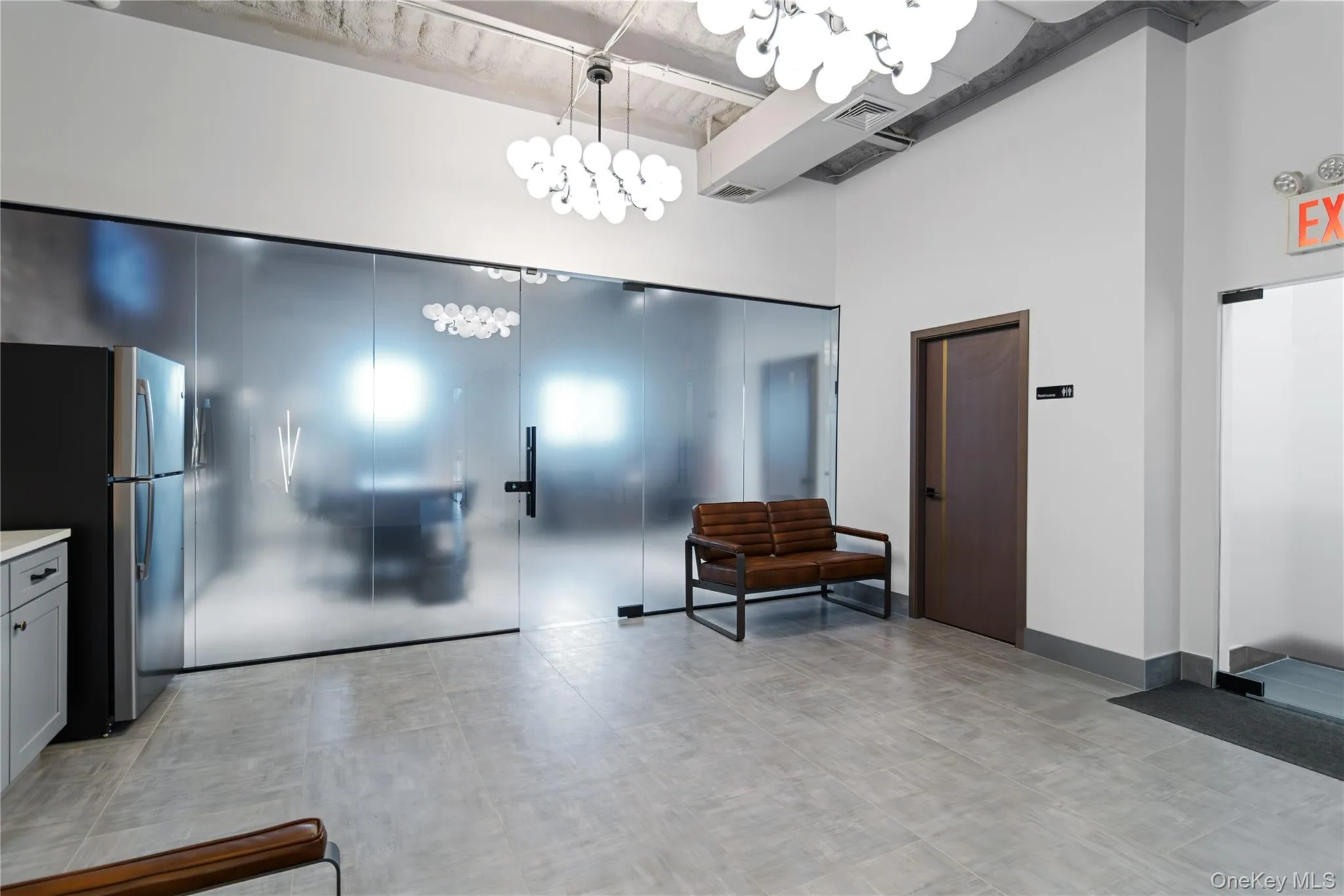 Common area featuring a high ceiling and beam ceiling Common area featuring a high ceiling and beam ceiling