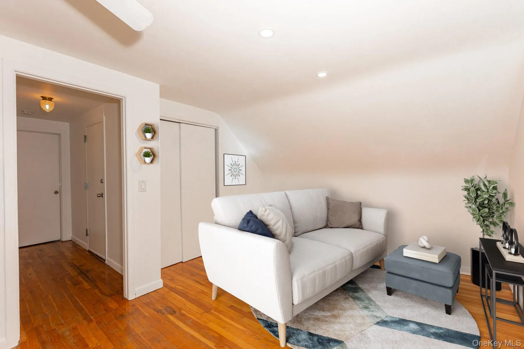 Sitting room featuring hardwood / wood-style floors, lofted ceiling, and recessed lighting Sitting room featuring hardwood / wood-style floors, lofted ceiling, and recessed lighting