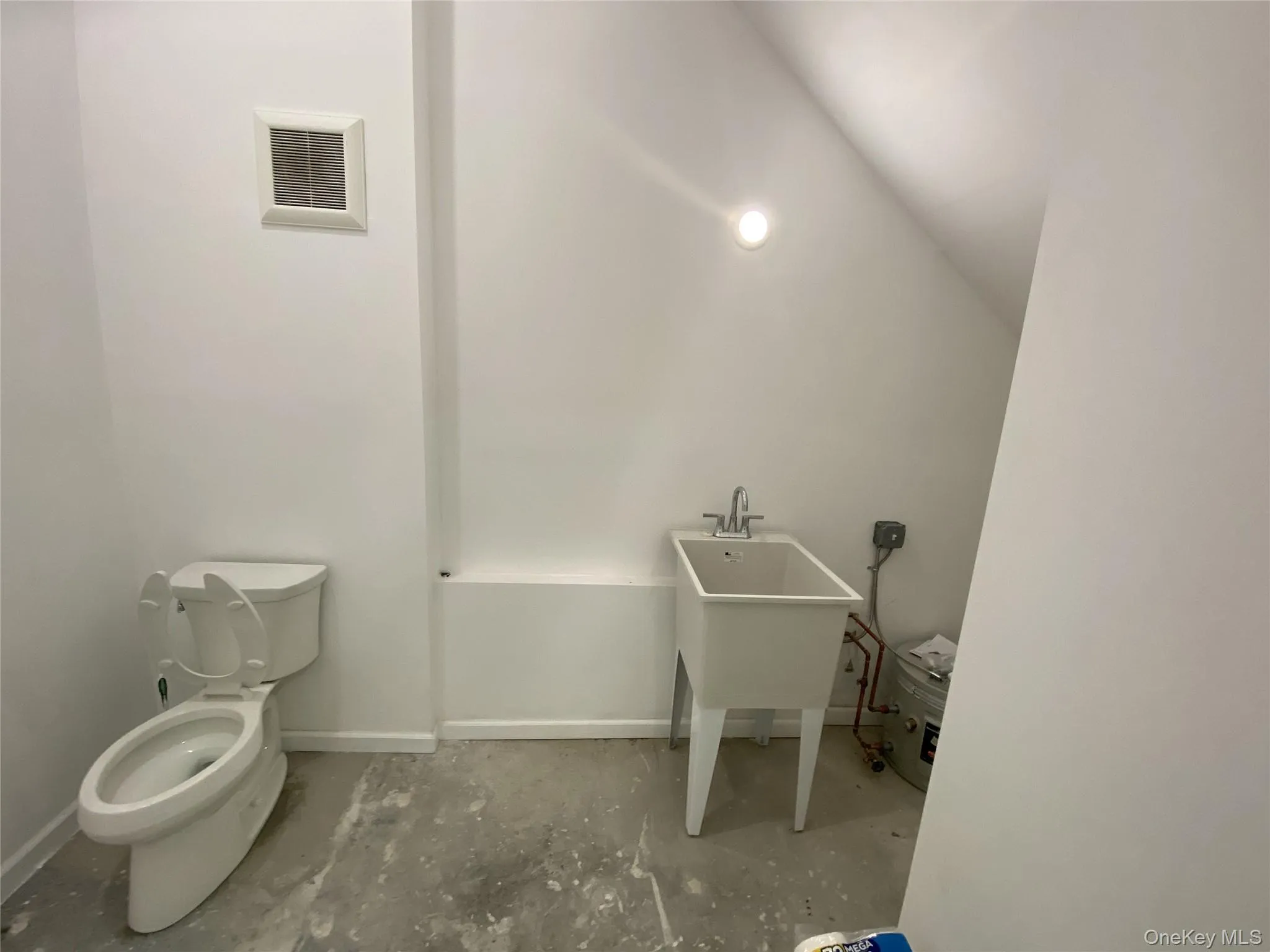 Half bathroom featuring toilet and baseboards Half bathroom featuring toilet and baseboards