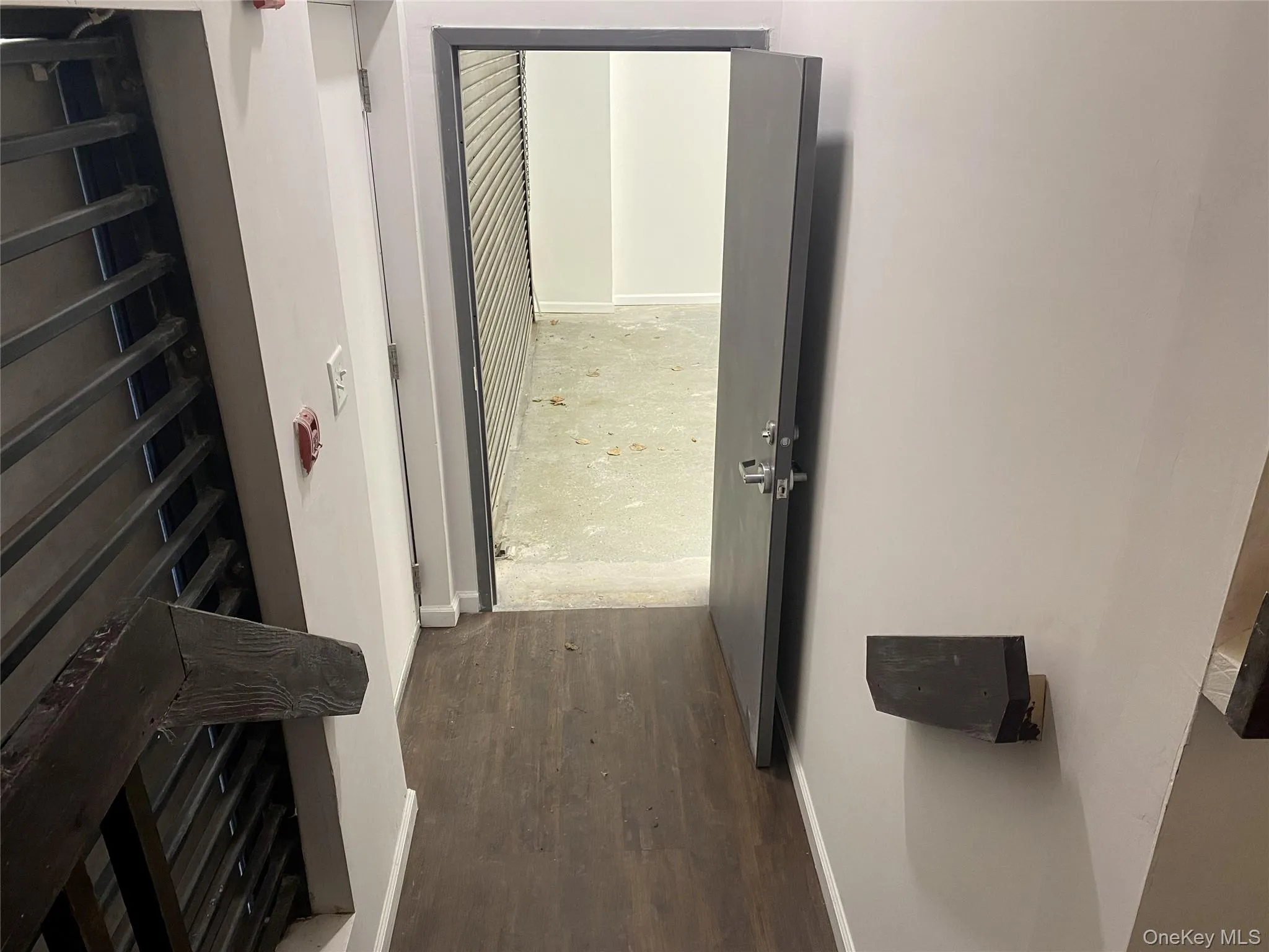 Corridor with baseboards and dark wood-style flooring Corridor with baseboards and dark wood-style flooring