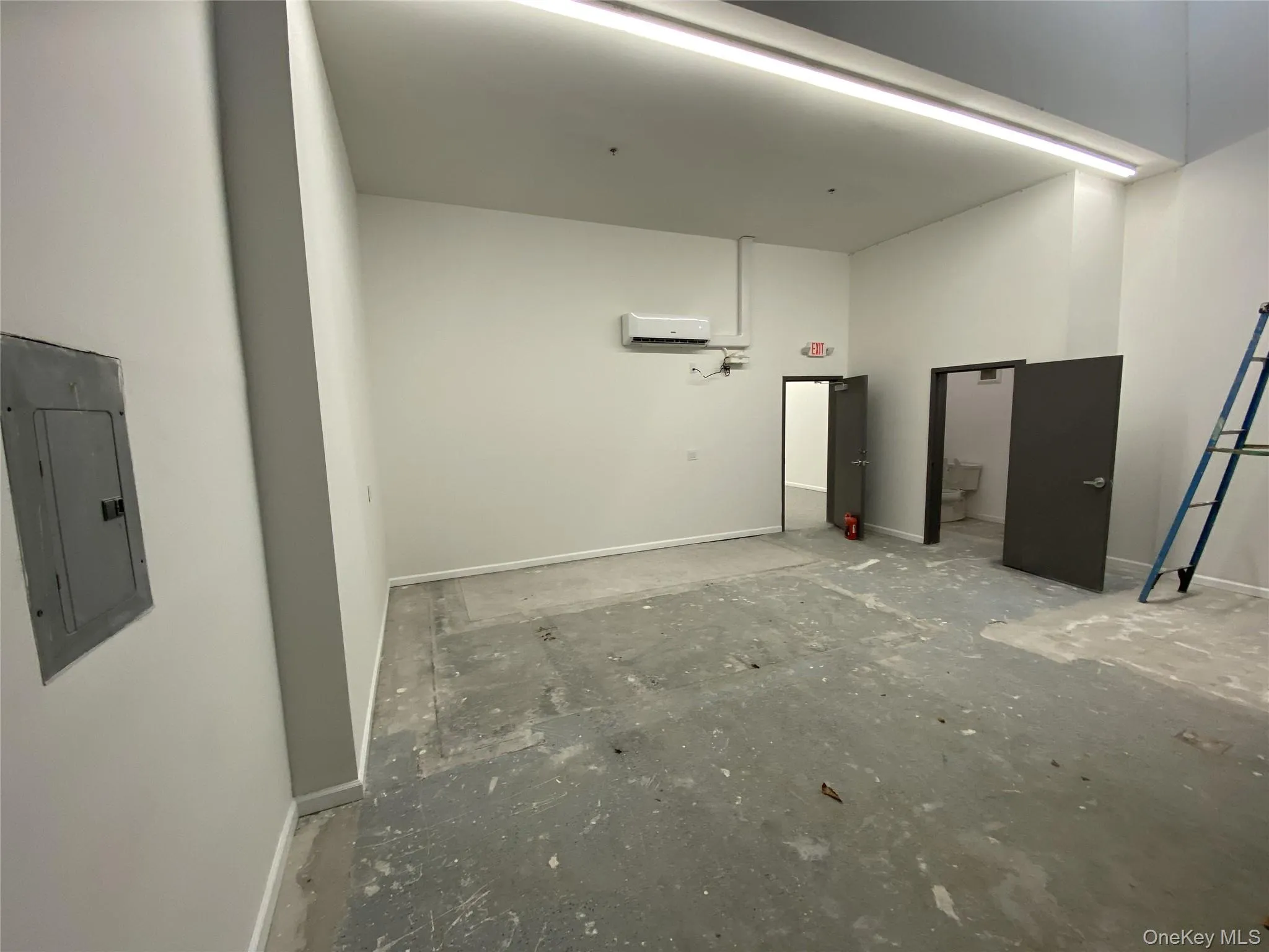 Garage with electric panel and baseboards Garage with electric panel and baseboards