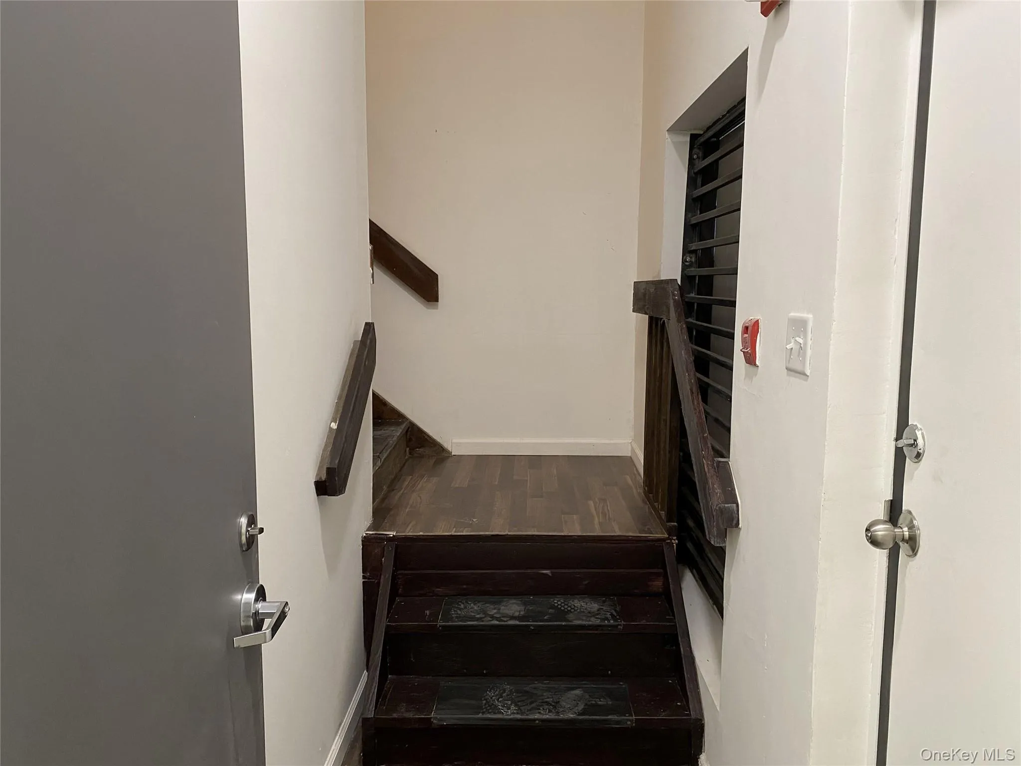 Staircase featuring baseboards and wood finished floors Staircase featuring baseboards and wood finished floors