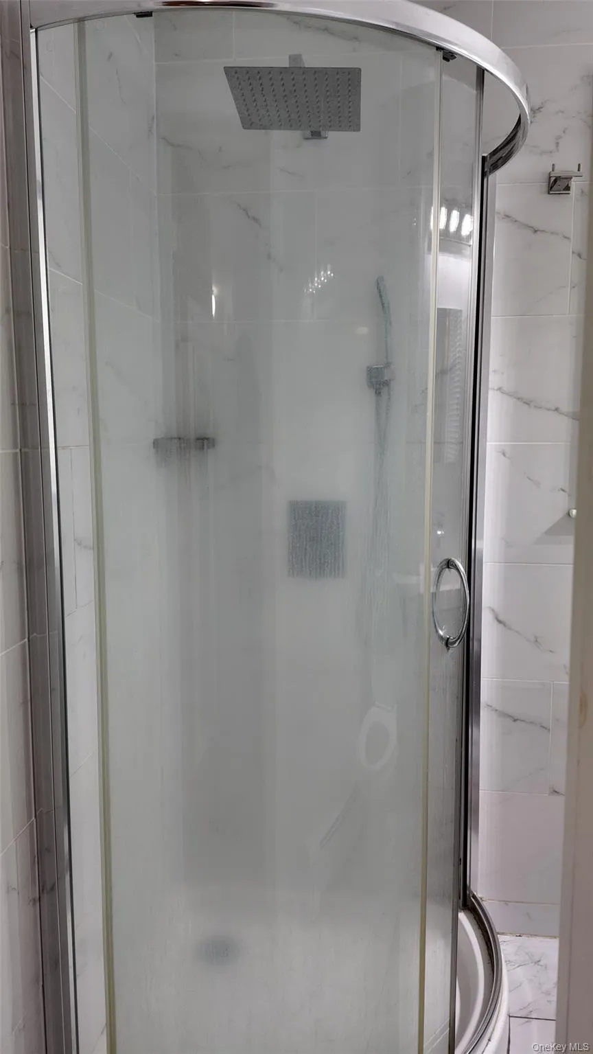 Bathroom with a marble finish shower Bathroom with a marble finish shower