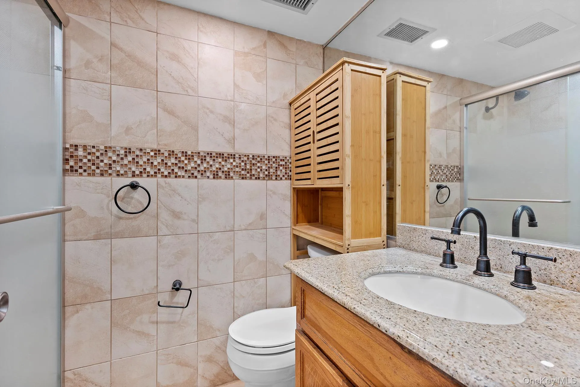 Full bath featuring vanity, a shower stall, tile walls, and recessed lighting Full bath featuring vanity, a shower stall, tile walls, and recessed lighting