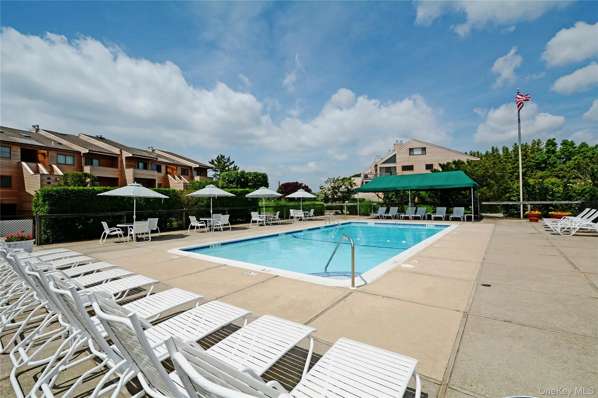 Community pool featuring a patio area and a residential view Community pool featuring a patio area and a residential view