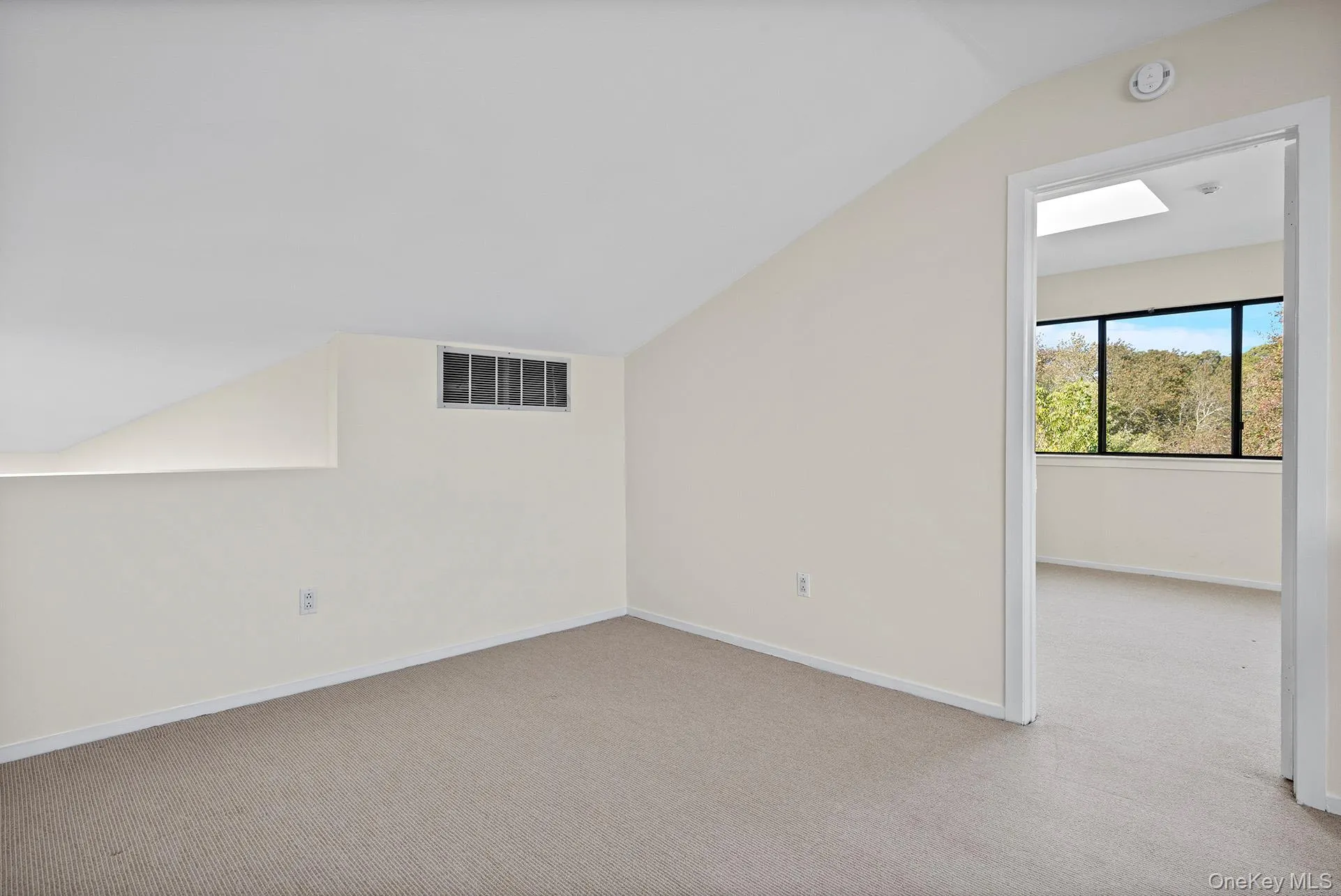 Loft space featuring vaulted ceiling, and and den beyond. Loft space featuring vaulted ceiling, and and den beyond.