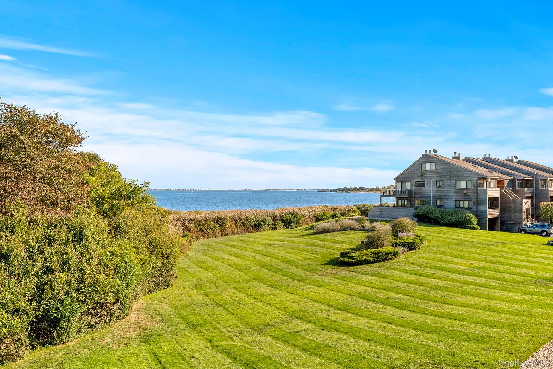View of green lawn with a water view overlooking paradise. View of green lawn with a water view overlooking paradise.