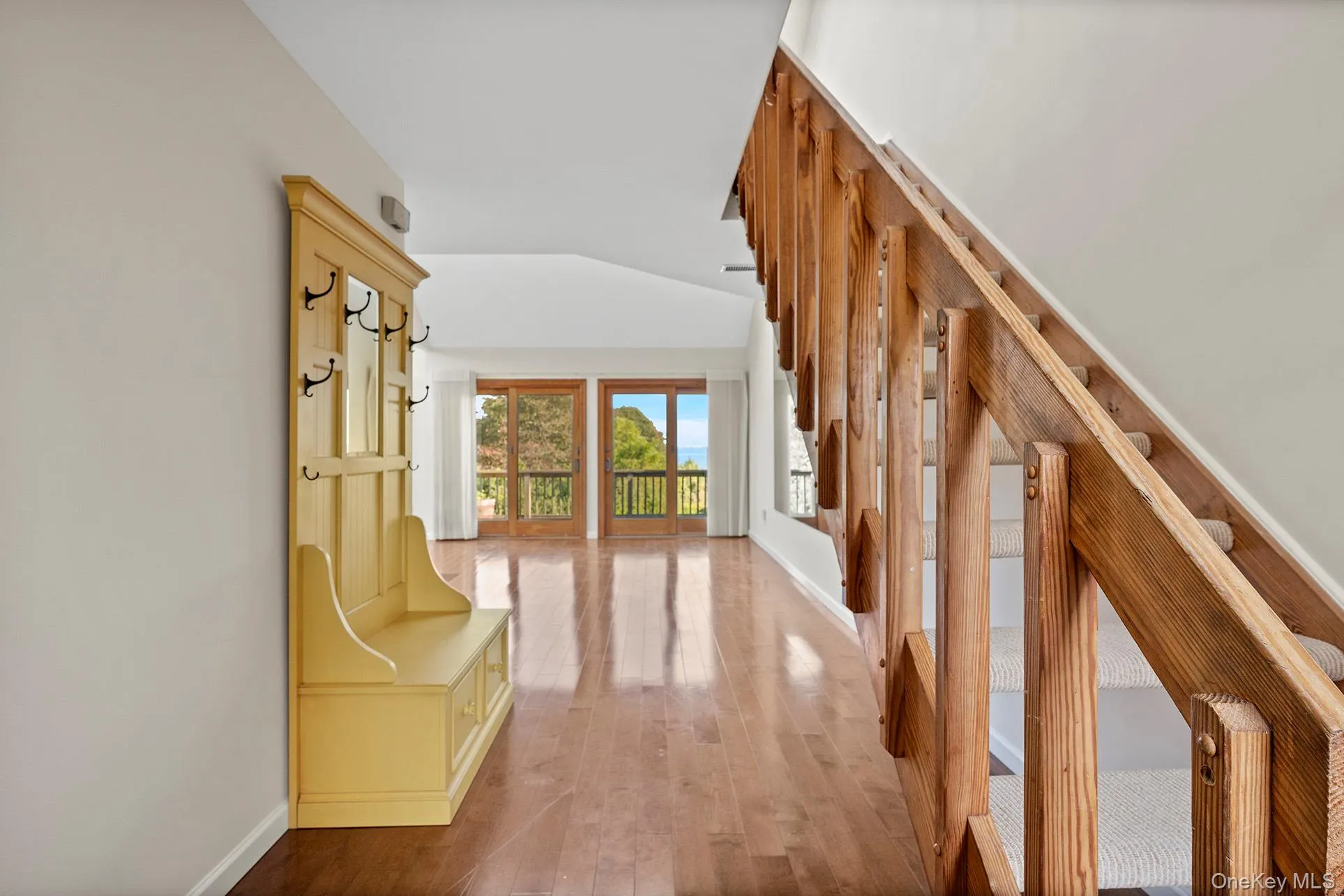 Hallway with wood floors and stairway to the Loft and Den With Vaulted Ceilings Hallway with wood floors and stairway to the Loft and Den With Vaulted Ceilings