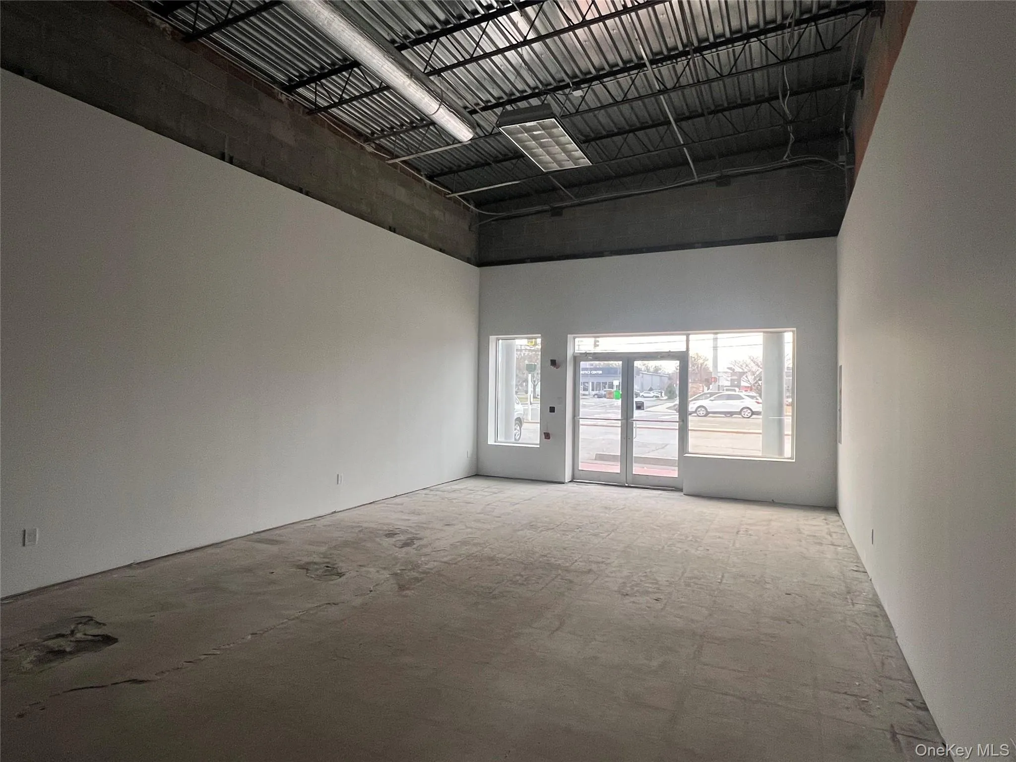 Unfurnished room featuring a towering ceiling Unfurnished room featuring a towering ceiling