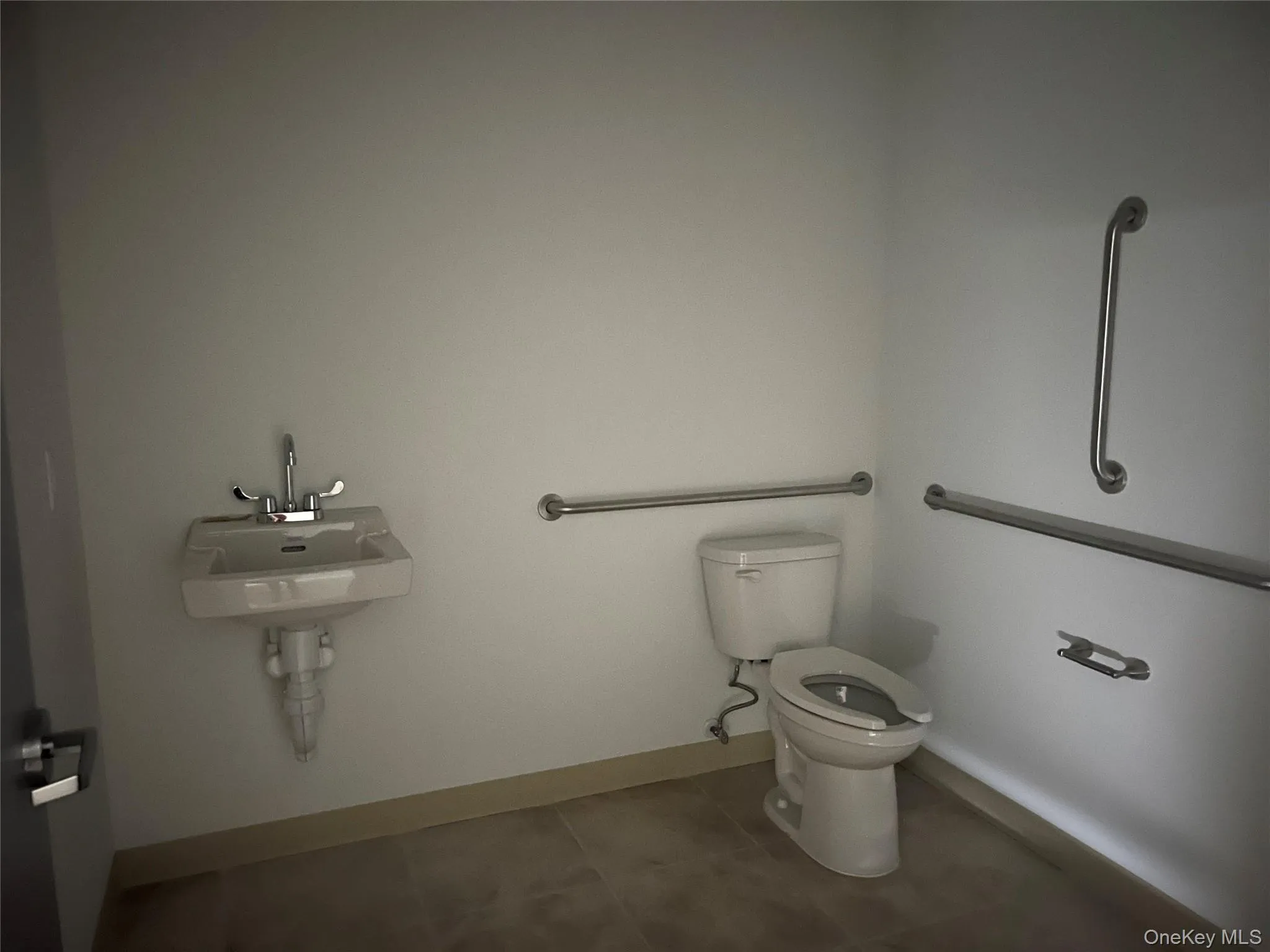 Half bath with baseboards and tile patterned flooring Half bath with baseboards and tile patterned flooring