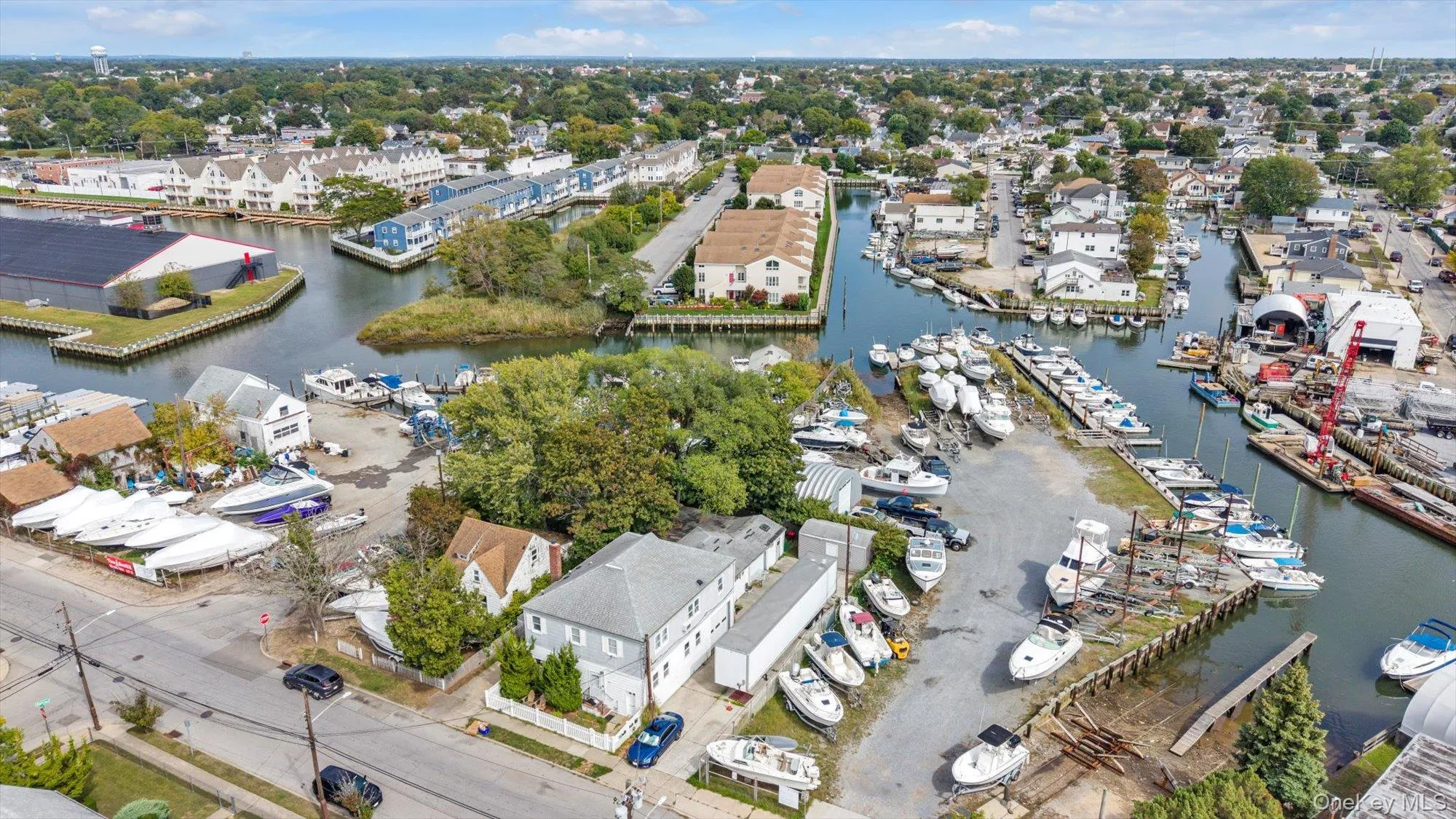Aerial perspective of suburban area with a nearby body of water Aerial perspective of suburban area with a nearby body of water