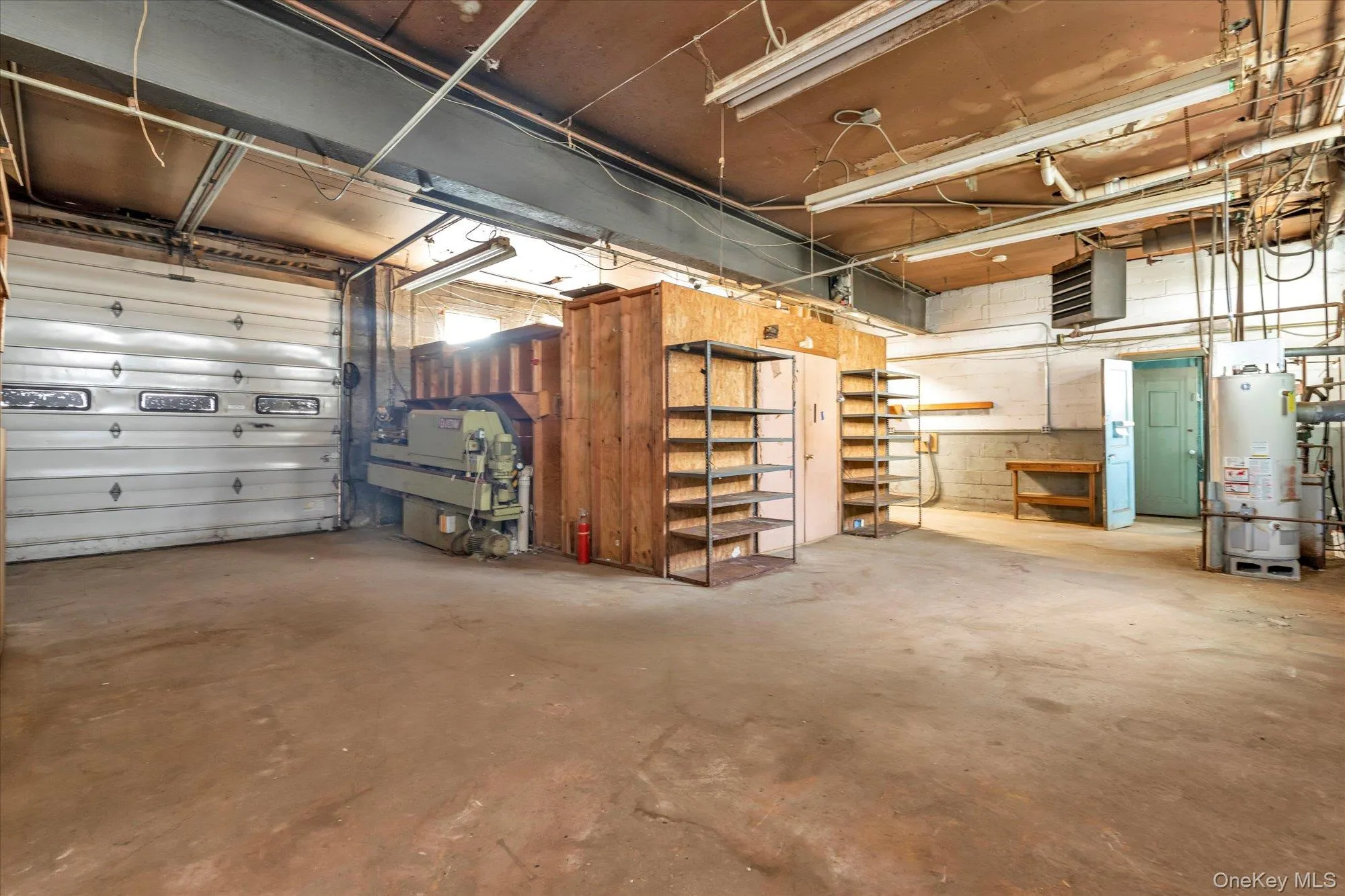 Garage featuring gas water heater and a heating unit Garage featuring gas water heater and a heating unit