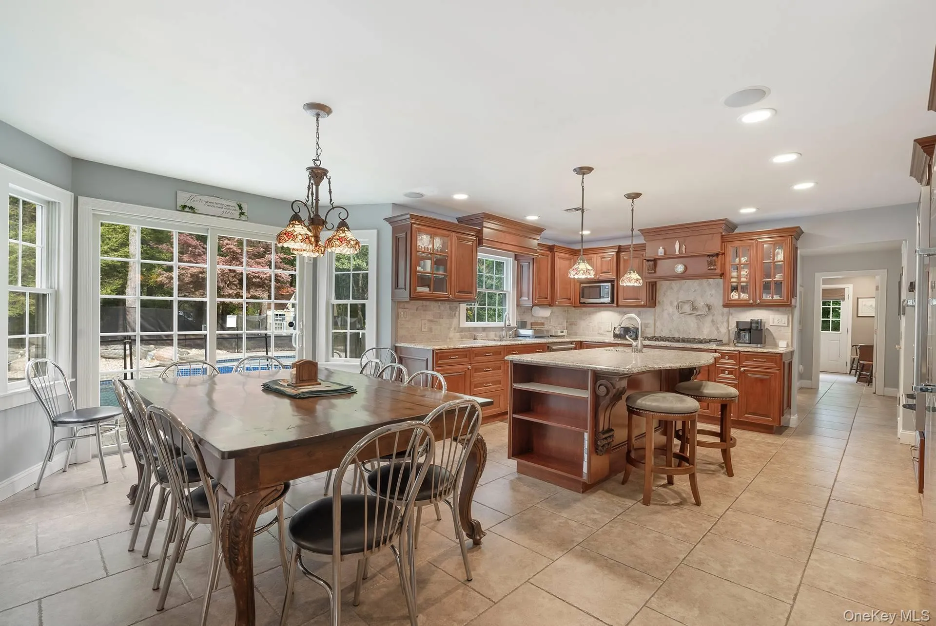 Dining area with recessed lighting and light tile patterned flooring Dining area with recessed lighting and light tile patterned flooring