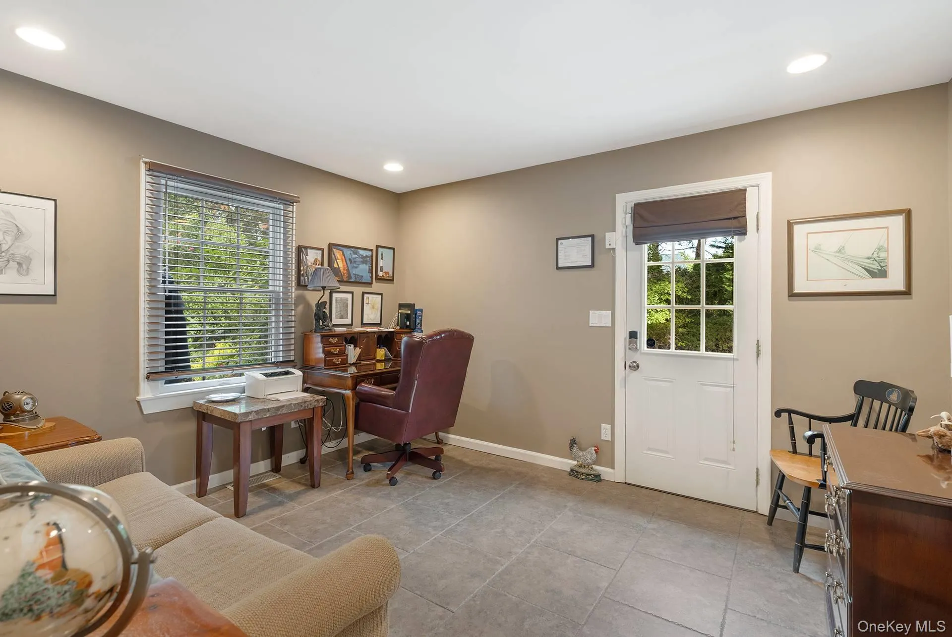 Office space with recessed lighting and light tile patterned floors Office space with recessed lighting and light tile patterned floors